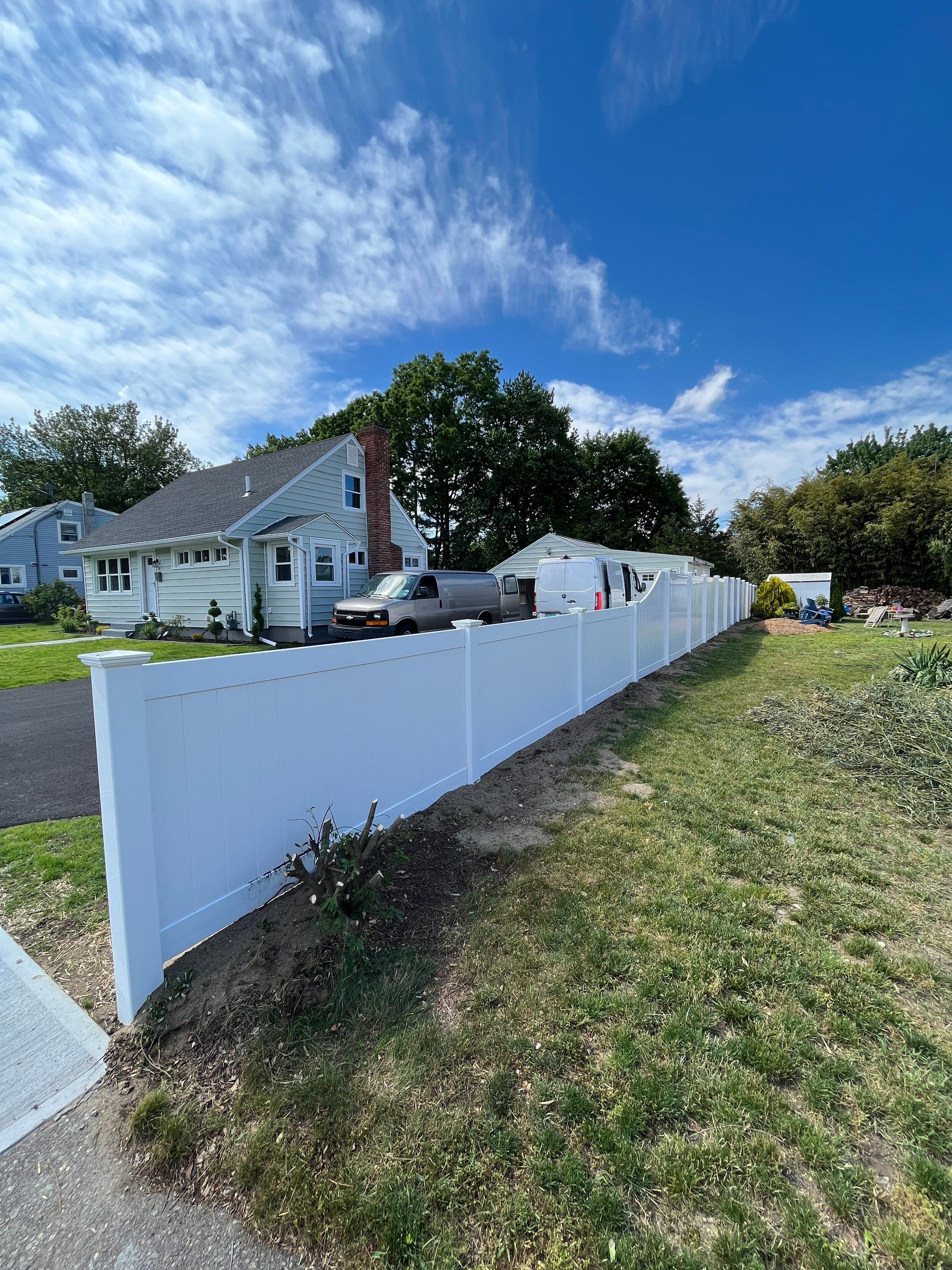 Replacement Vinyl Privacy fence with Transition piece in White by DiGiorgi Roofing and Siding Inc
