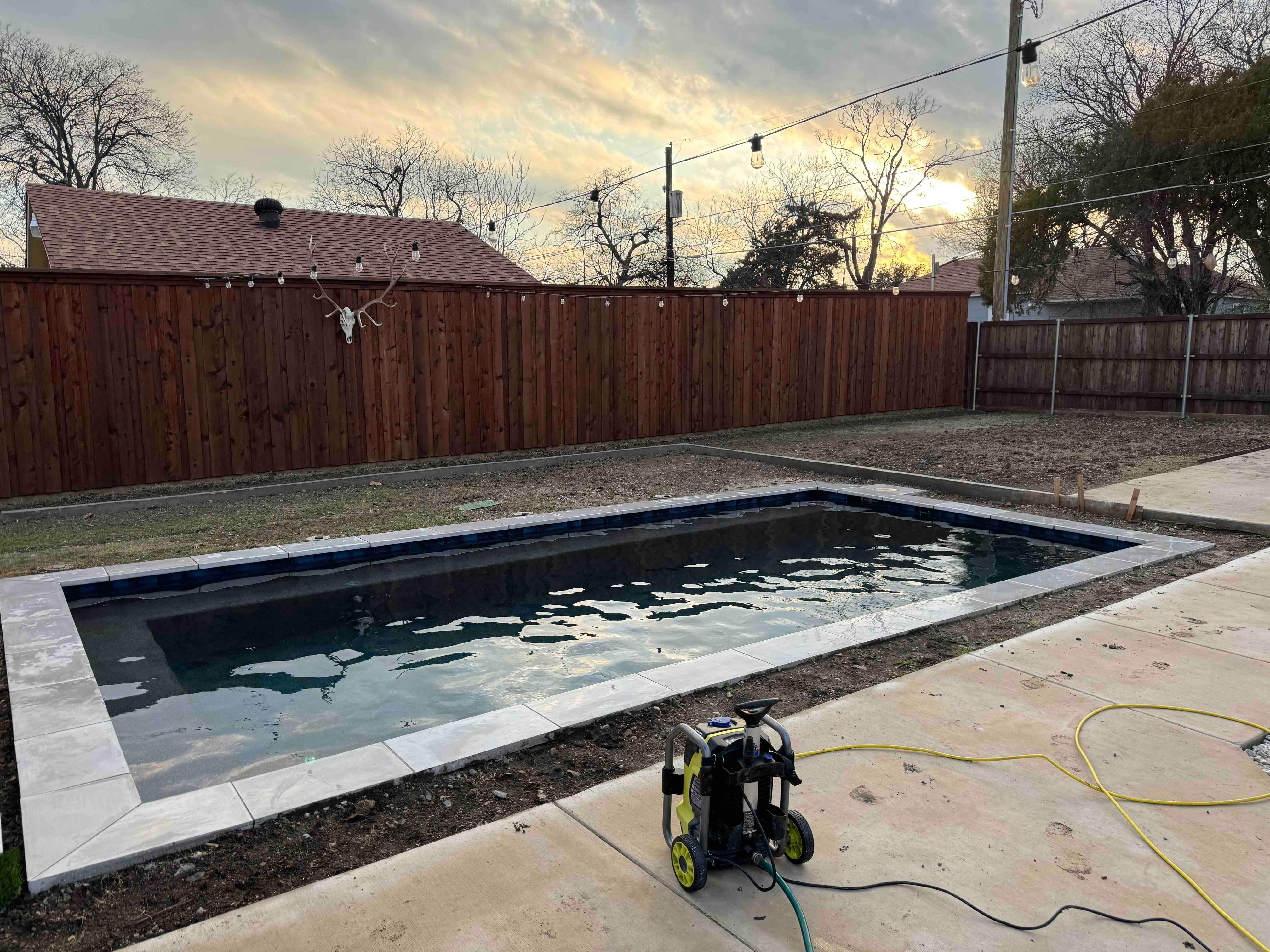 Modern Pool with Dark Interior and Deck Jets by Pinnacle Pools and Spas - DFW