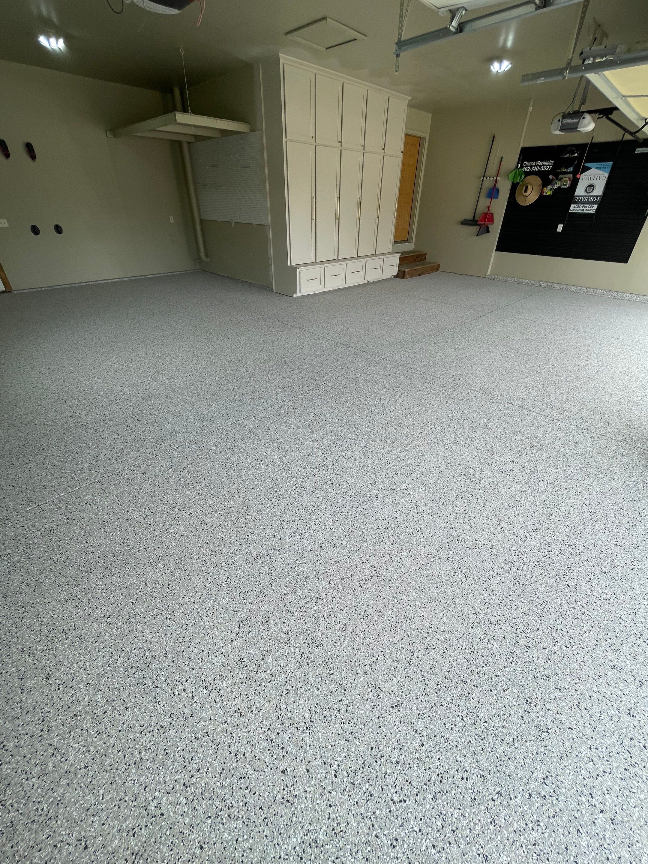 Cabin FEver Flake Garage Floor Coating Installation in Sioux Falls by Select Painting, Coatings & Garage Cabinets