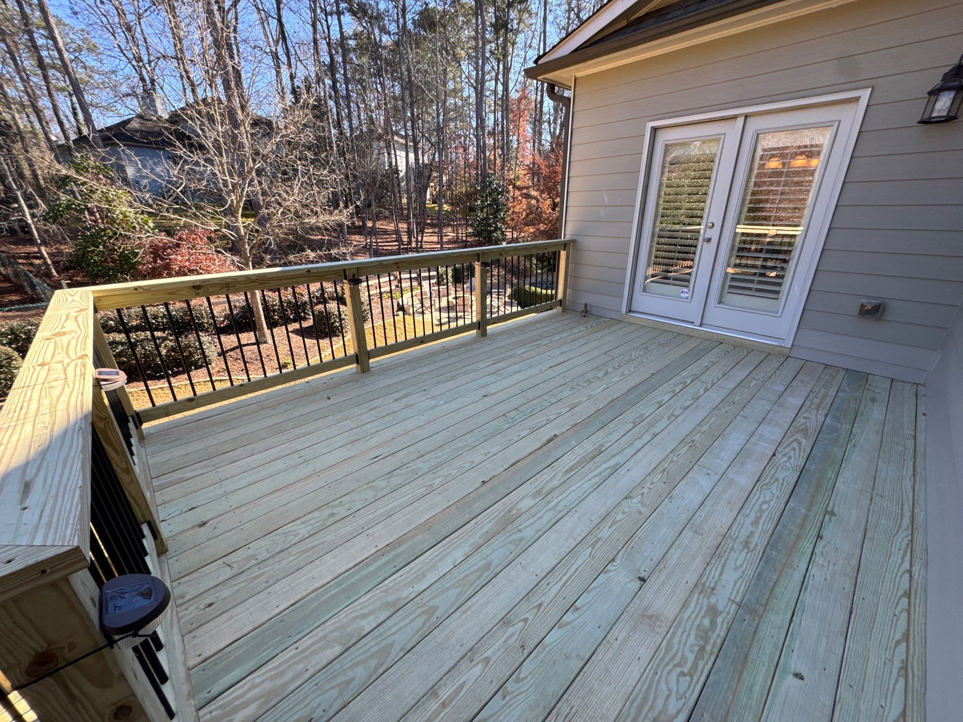 Custom Pressure-Treated Deck with Metal Balusters in Marietta by Swift Home Renovations
