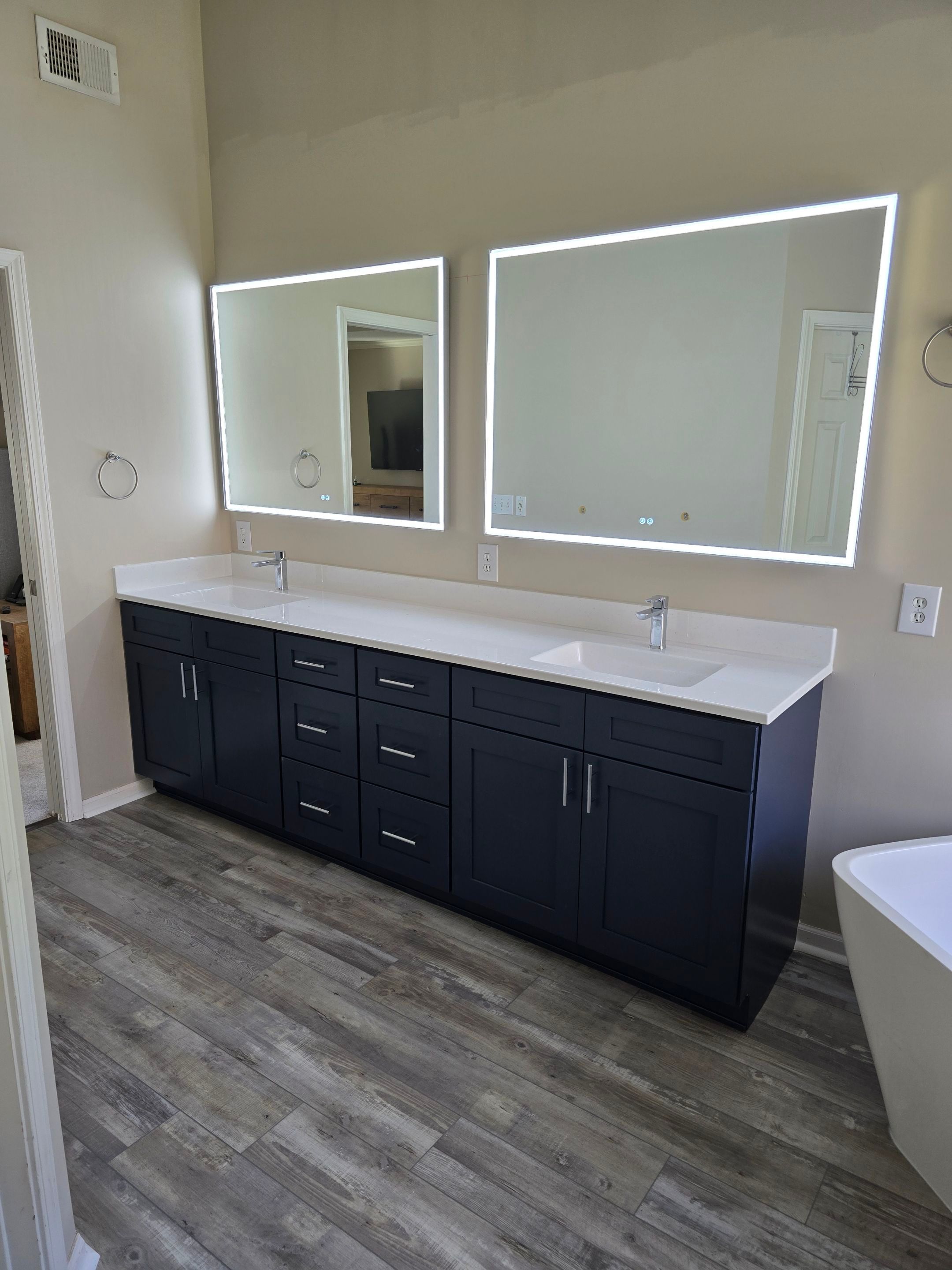 Full bathroom remodel with Artus lighted mirrors, Waltz bathtub and Mercury doors by The Shower Company