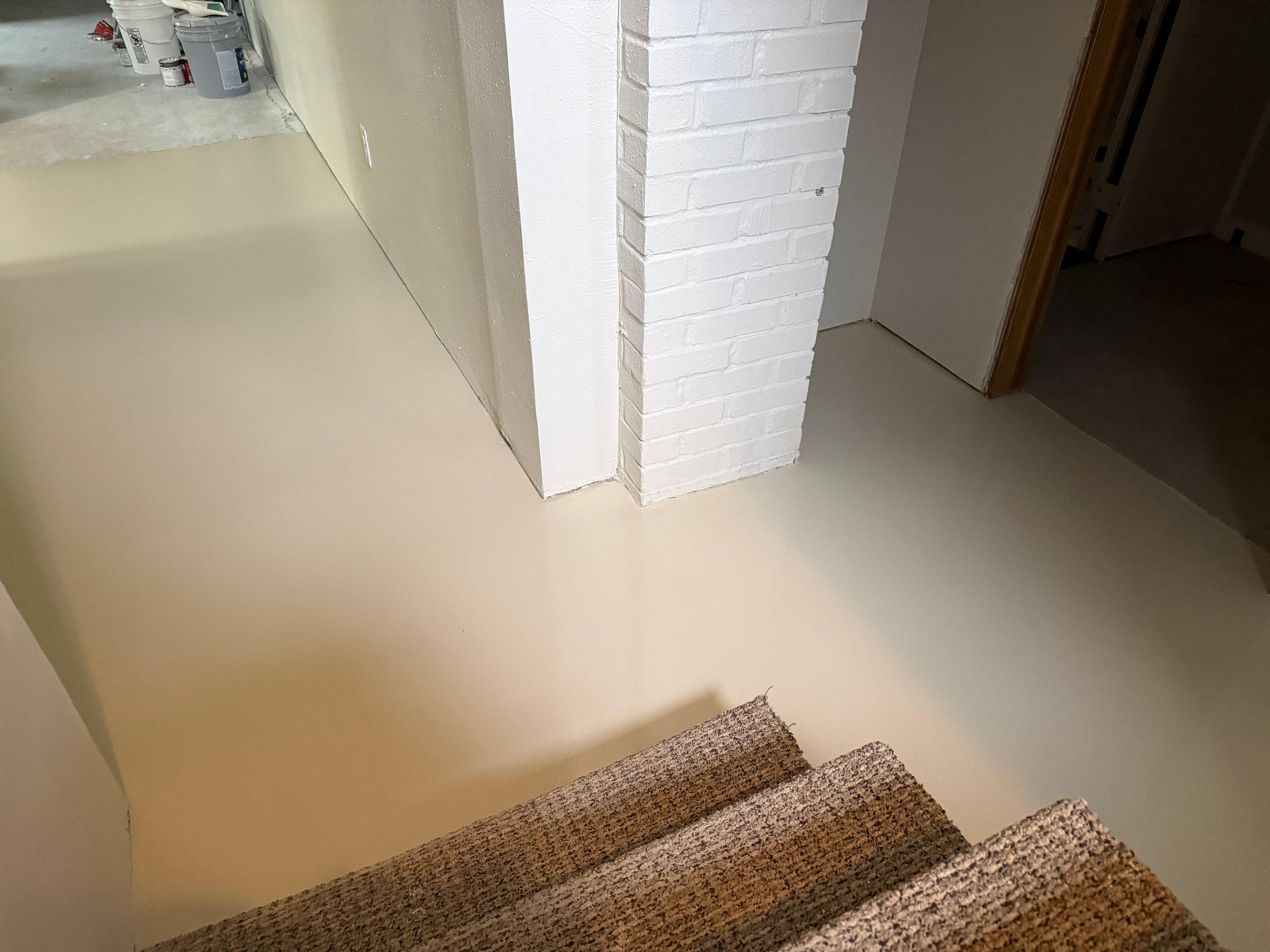 High-Gloss Epoxy Floor Coating and Basement Renovation in Rock Rapids by Select Painting, Coatings & Garage Cabinets