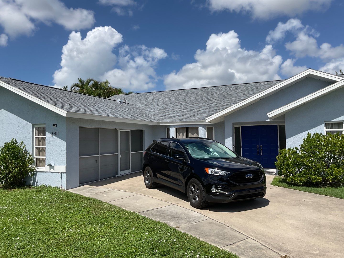 New White Seamless Gutters with Downspouts and Splash Guards in Cape Coral FL by Gutter Professors