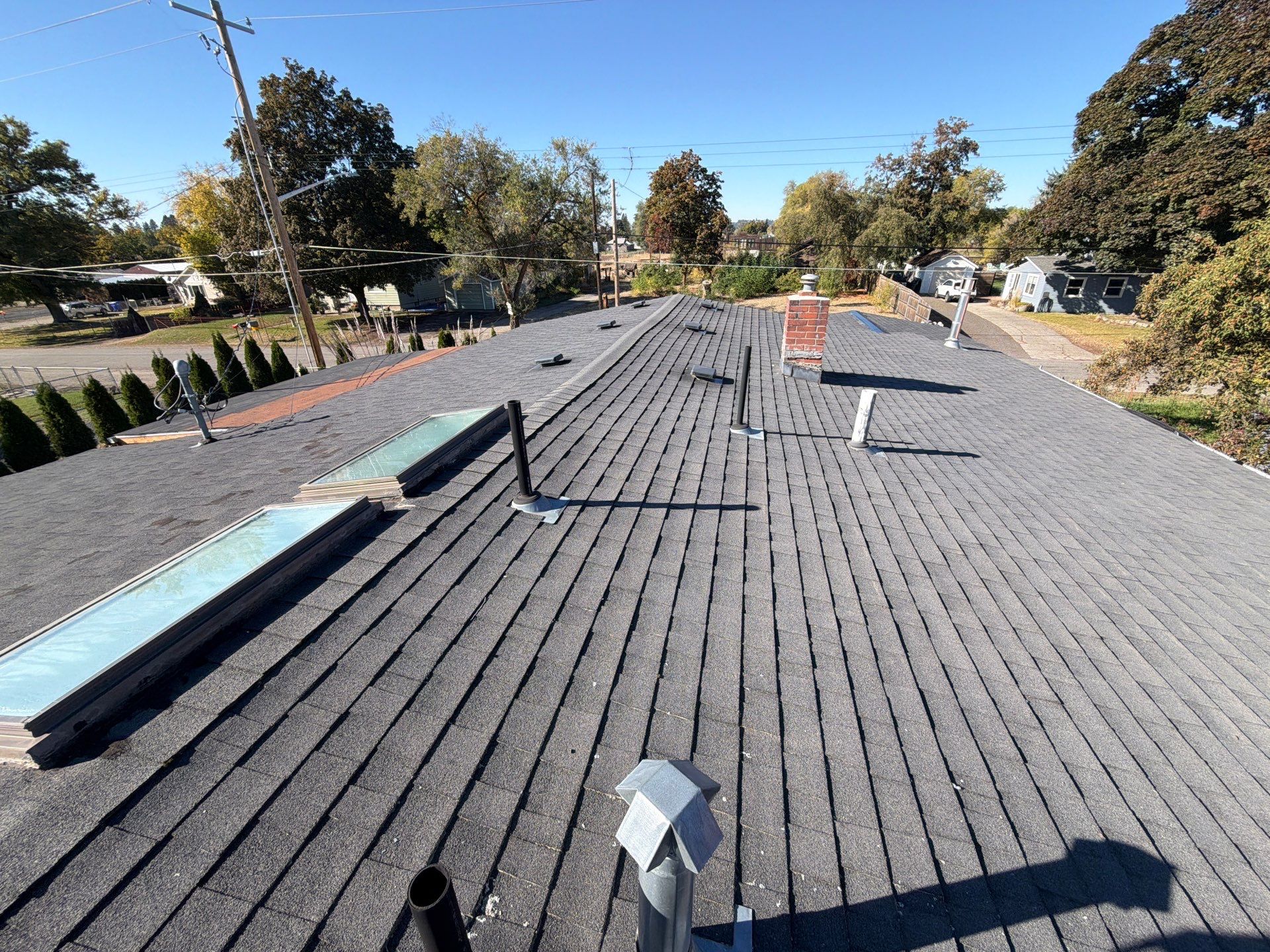 Residential Asphalt Shingle Roof Replacement and Skylight Installation in Spokane by Alpine Roofing