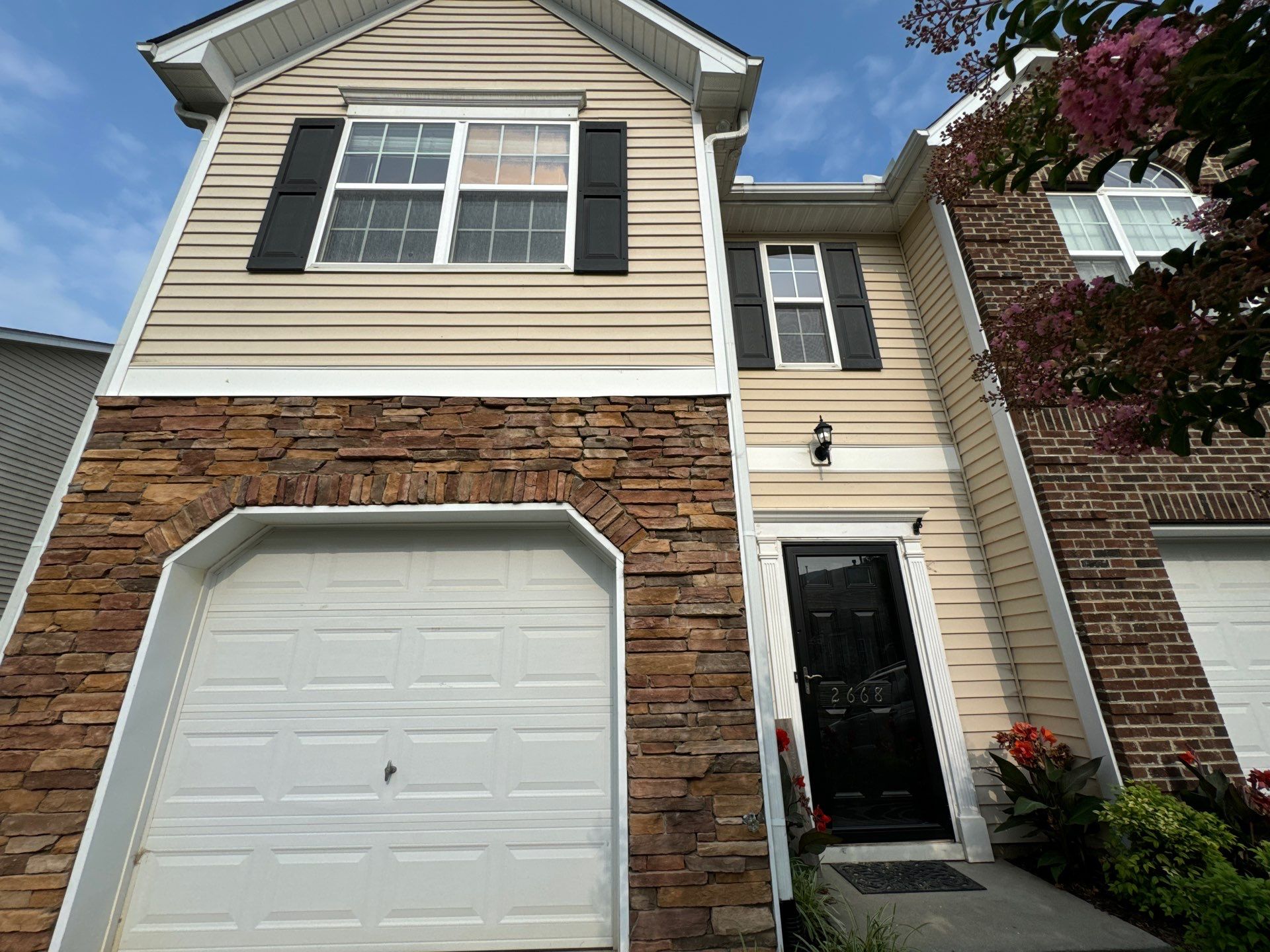 pressure washing exterior siding driveway stone walls garage door and pathways