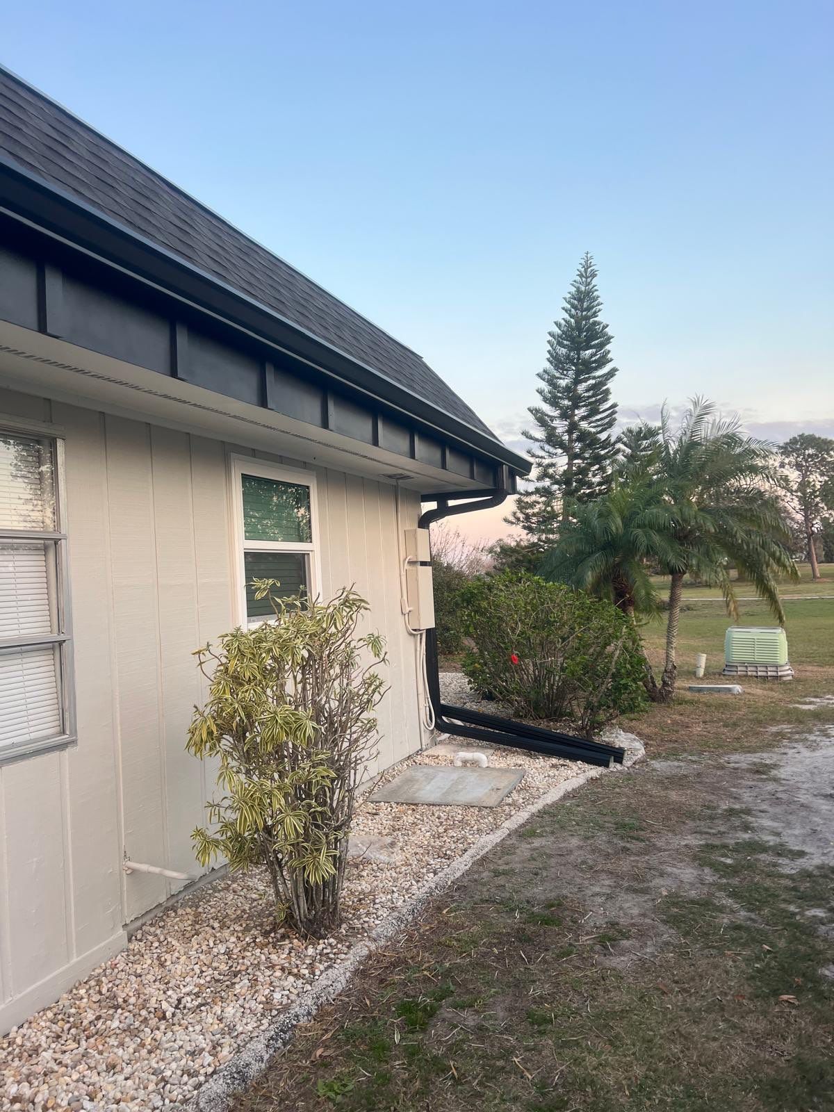 Black 6'' Seamless Gutters K-Style and Black Downspouts in Sun City Center FL by Gutter Professors