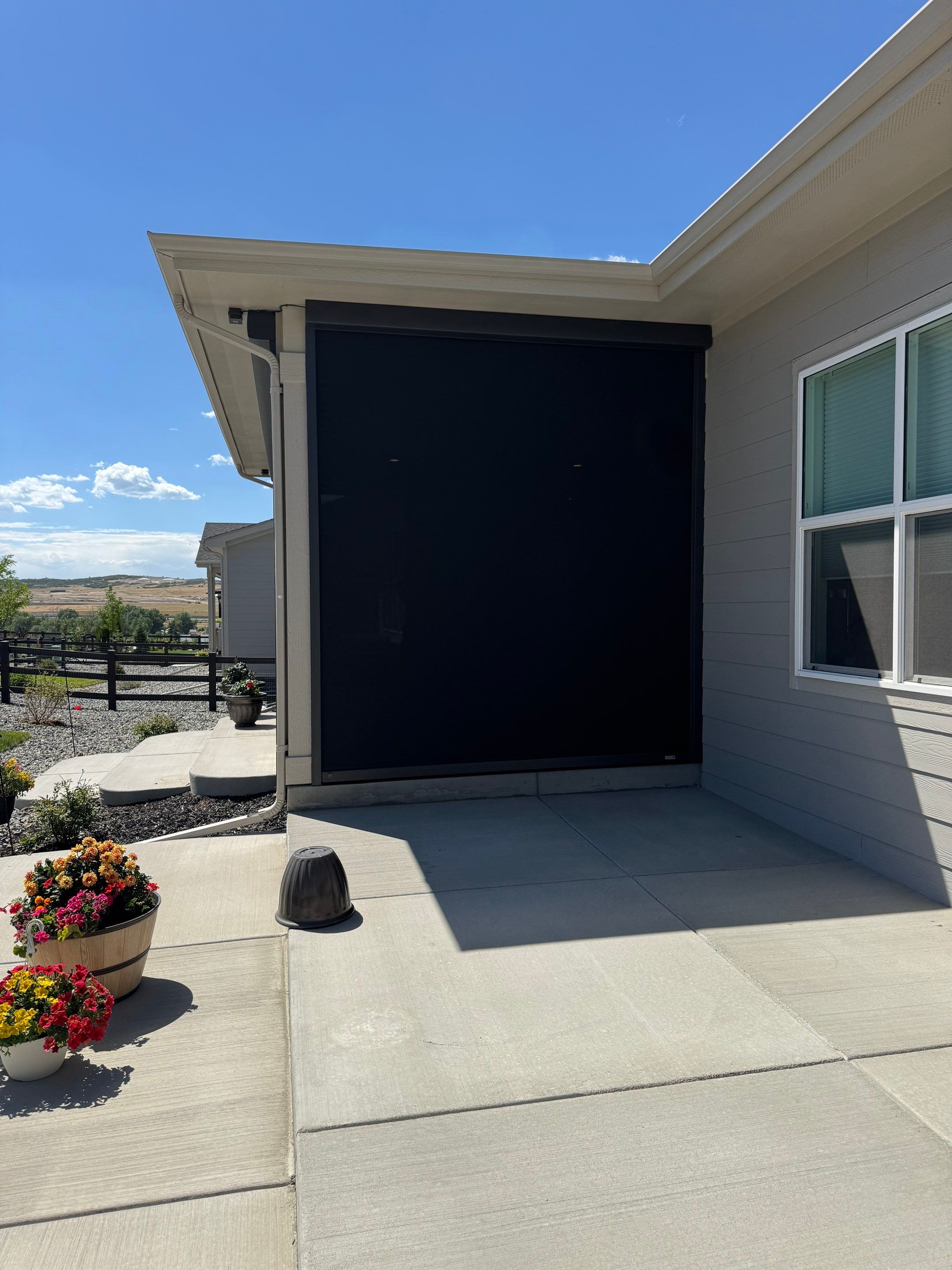 Retractable All-Weather Screen Installation for Castle Rock Covered Patio by Outdoor Solutions Colorado