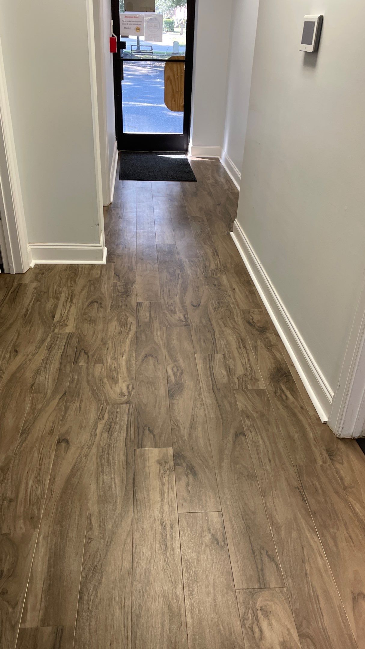 Office Remodel from Worn Out Carpet to Sleek Glued Down LVP by Footprints Floors of Coastal Carolina