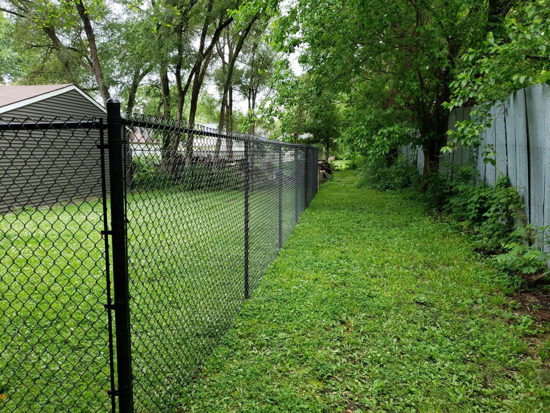 Black Vinyl Chain Link Fence Installation in Charles City by Perfect Picket Fence and Stain