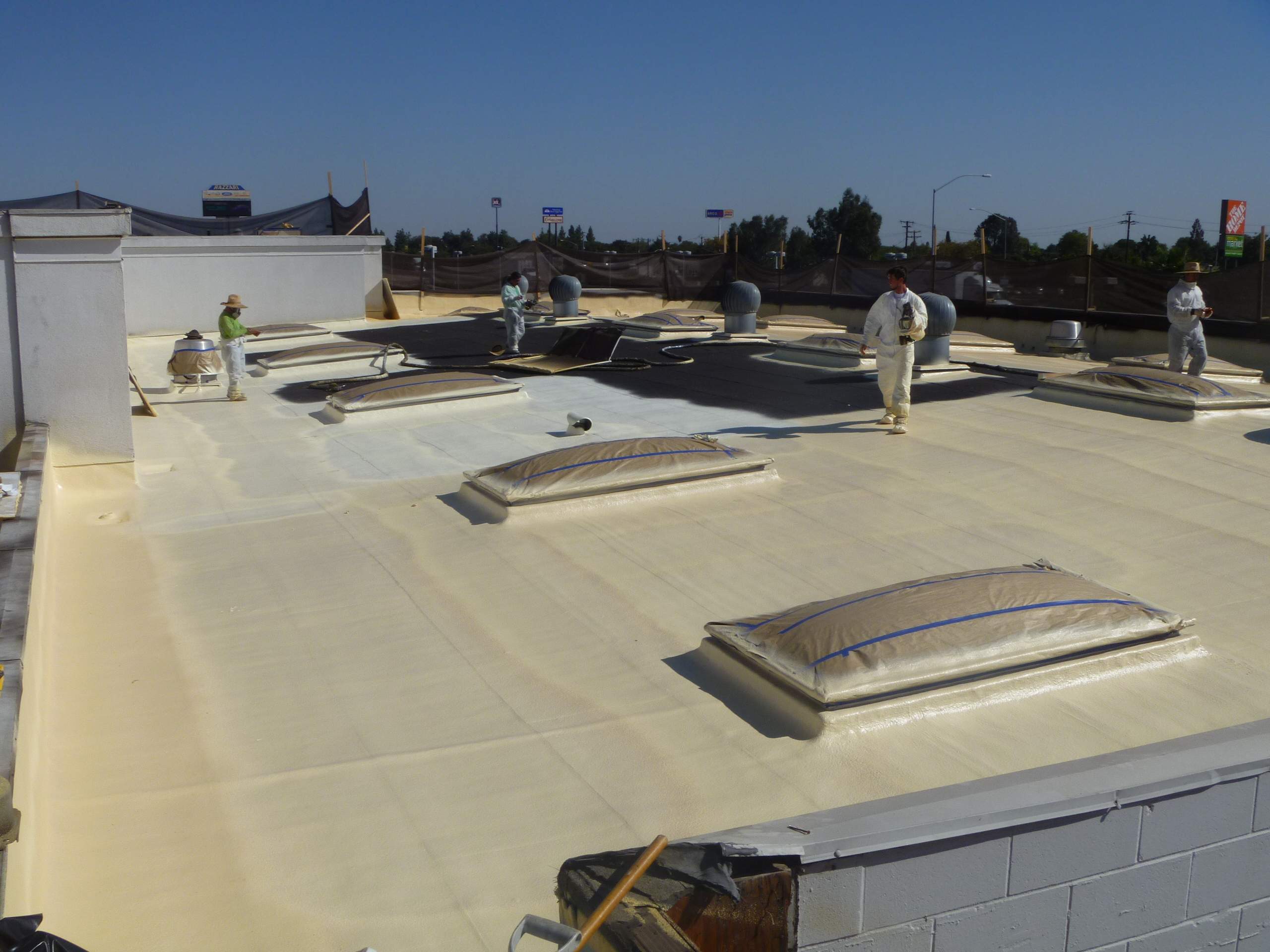 Commercial Roofing Installation using Spray foam and Conklin Benchmark/PUMA XL 18 yr warranty coatings by Straight Edge Roofing Inc