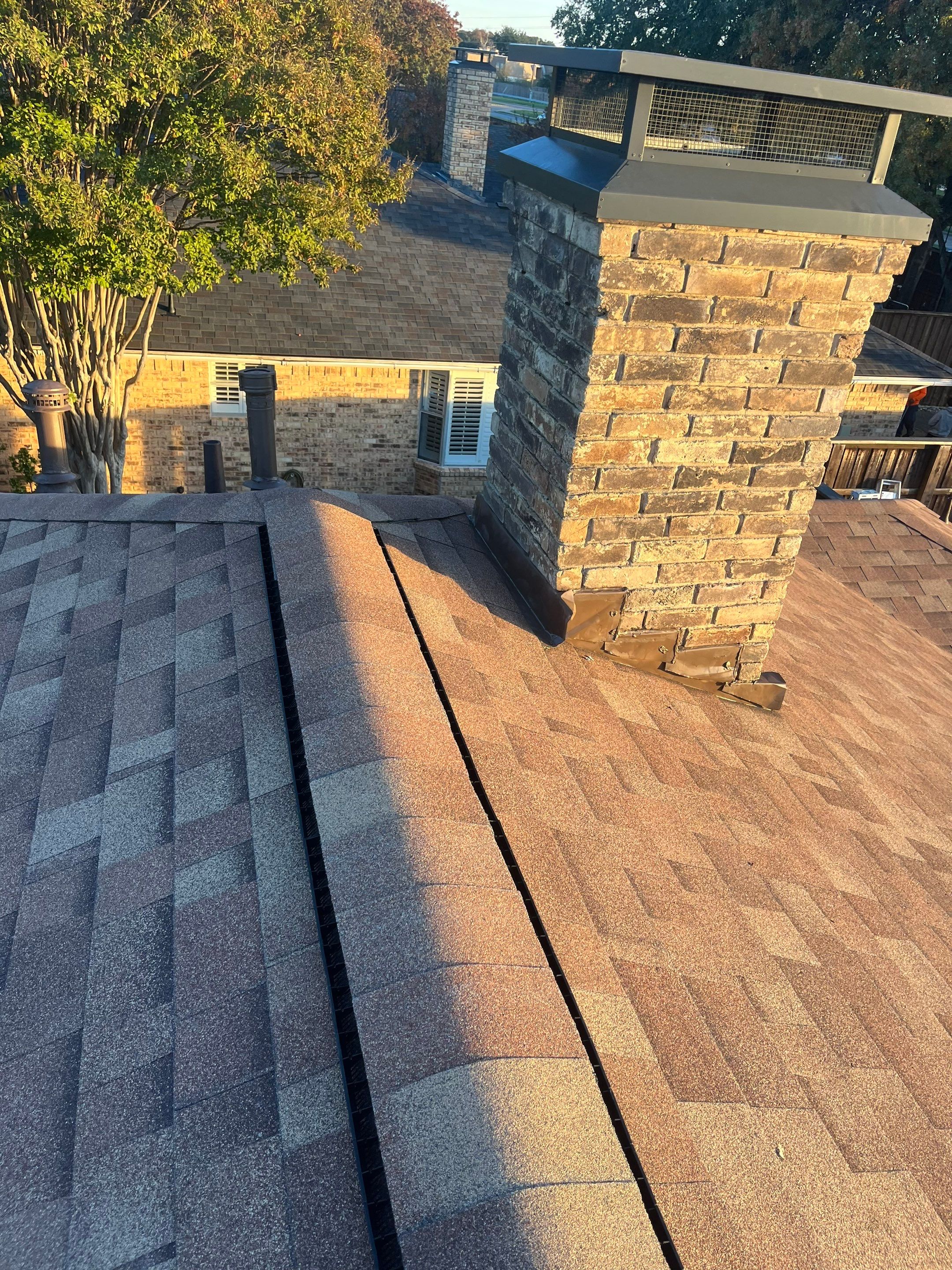 Brick with white area around windows with Malarkey Sienna Blend by Tejas Roofworks + Restoration