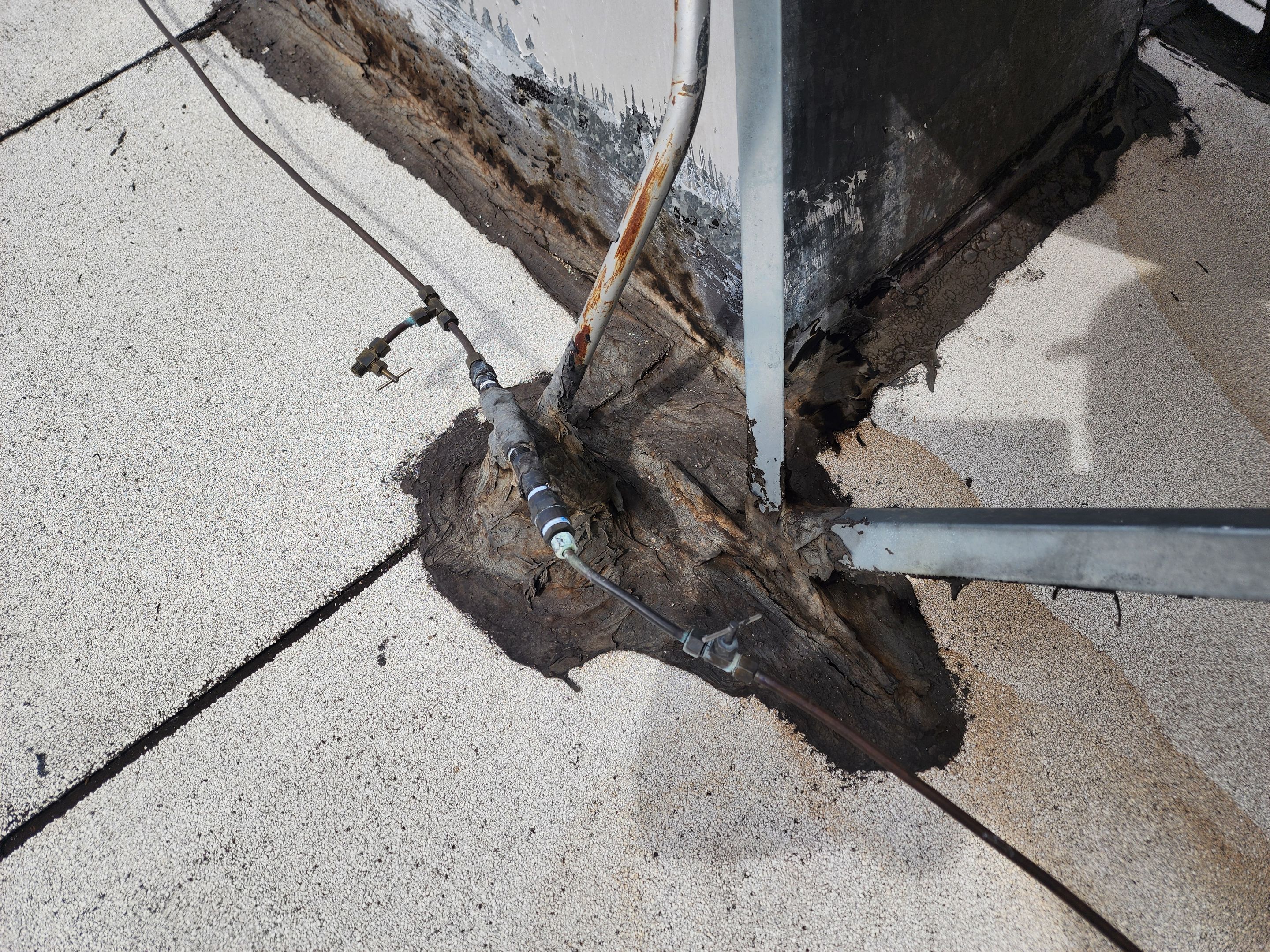 Foam and coatings on commercial roof by Straight Edge Roofing Inc