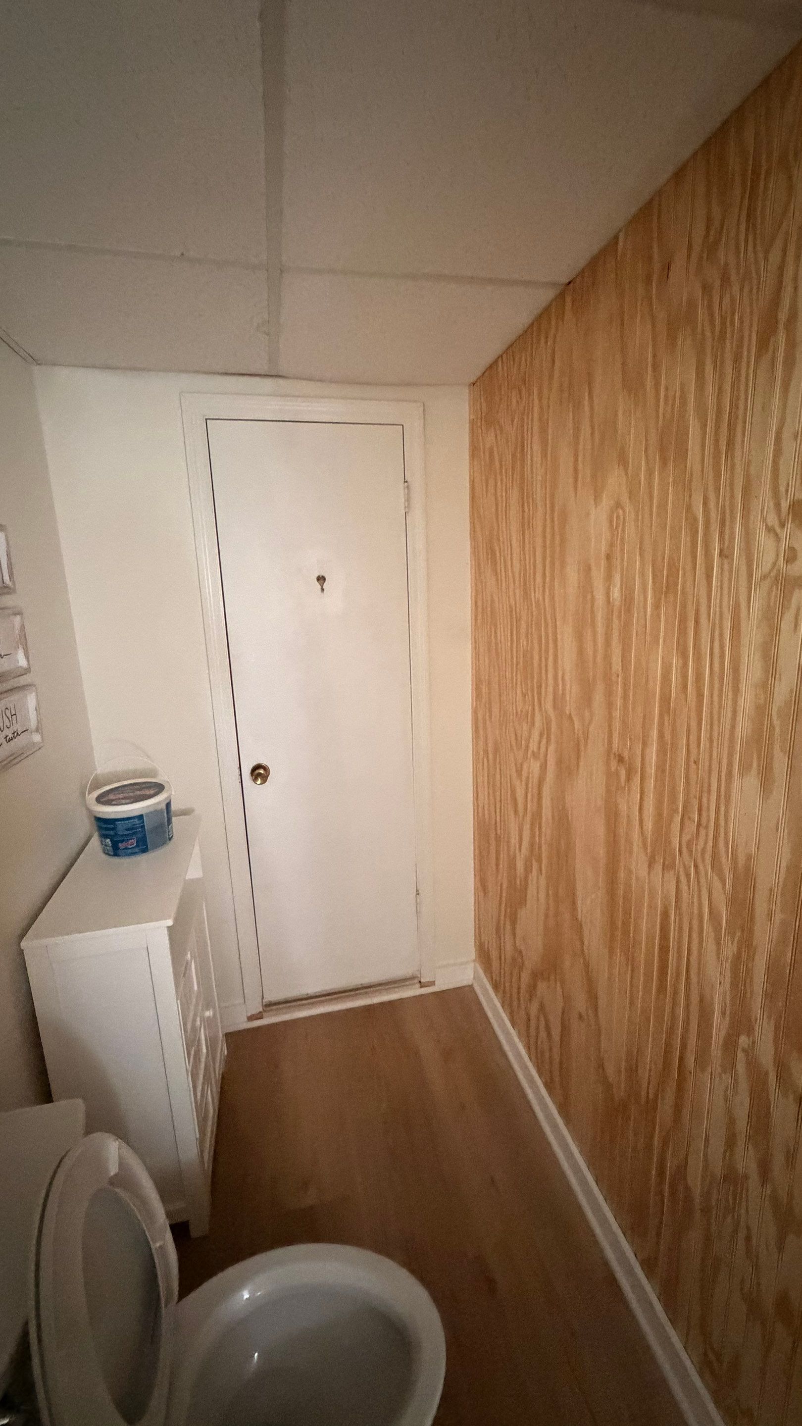 Basement Remodeling with Wood-Look Flooring and Custom Wainscoting in Dunwoody by Swift Home Renovations