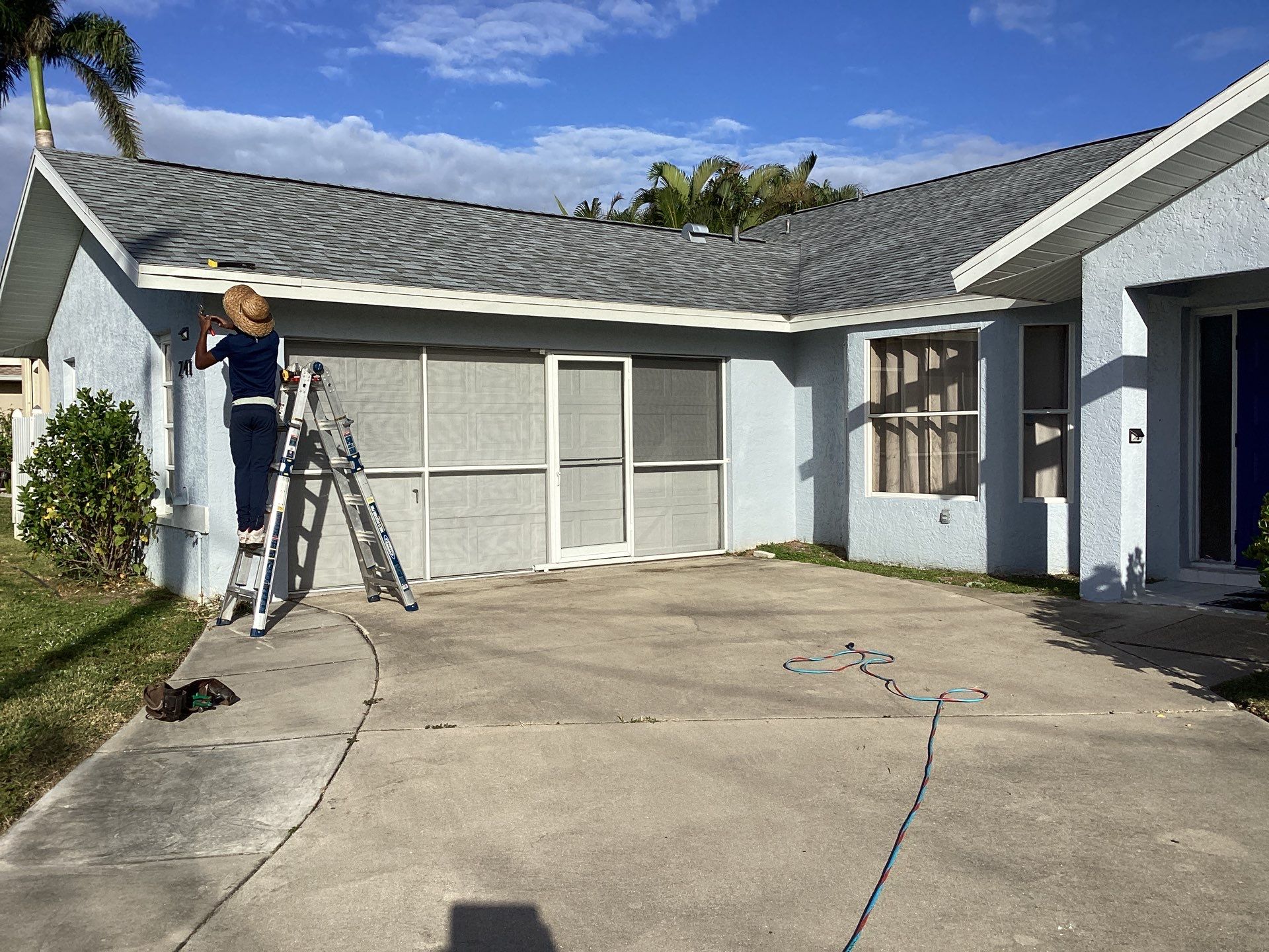 New White Seamless Gutters with Downspouts and Splash Guards in Cape Coral FL by Gutter Professors