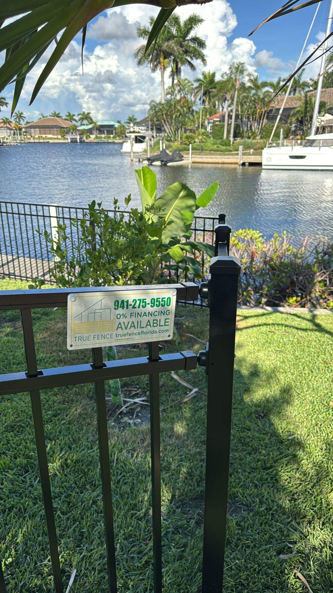 Black Aluminum Fence Installation Along Punta Gorda Canal by True Fence LLC