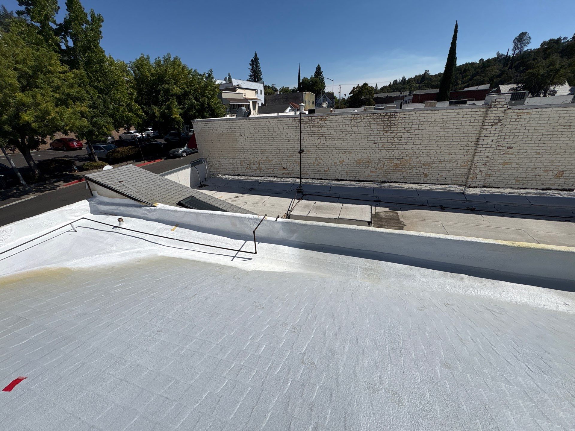 Foam and coatings on commercial roof by Straight Edge Roofing Inc