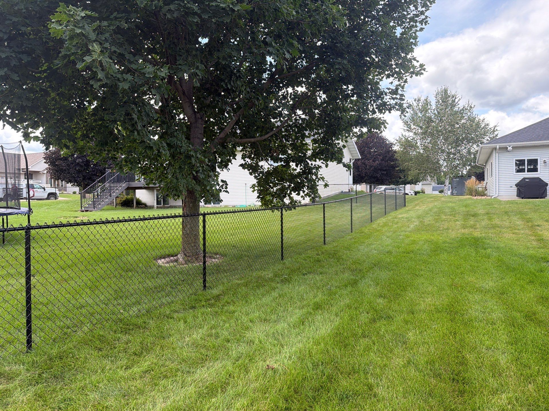 Black Vinyl-Coated Chain Link Fence Installation in Fairbank by Perfect Picket Fence and Stain