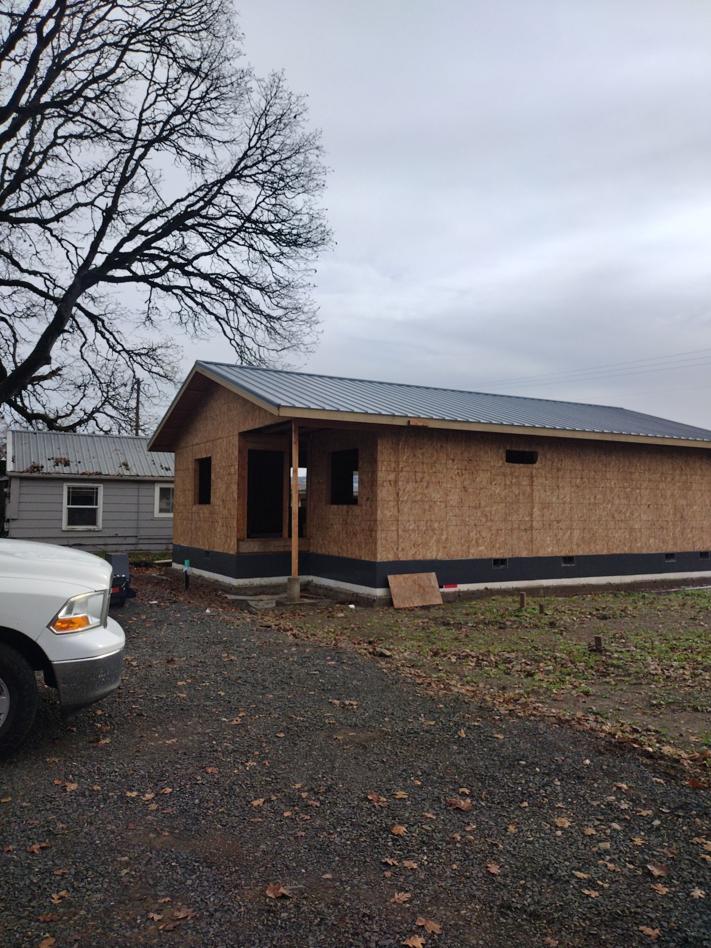 Grey Habitat for Humanity Metal Roof by Orezona Building & Roofing Company, Inc.