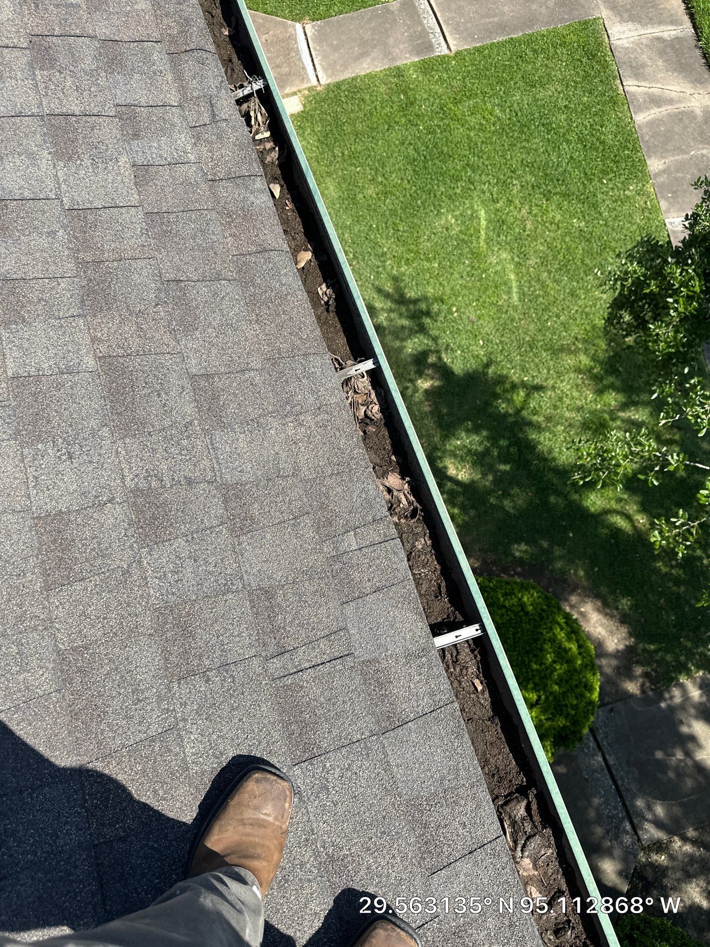 HOA gutter cleaning in Pearland, TX,before  photo showing full gutters.