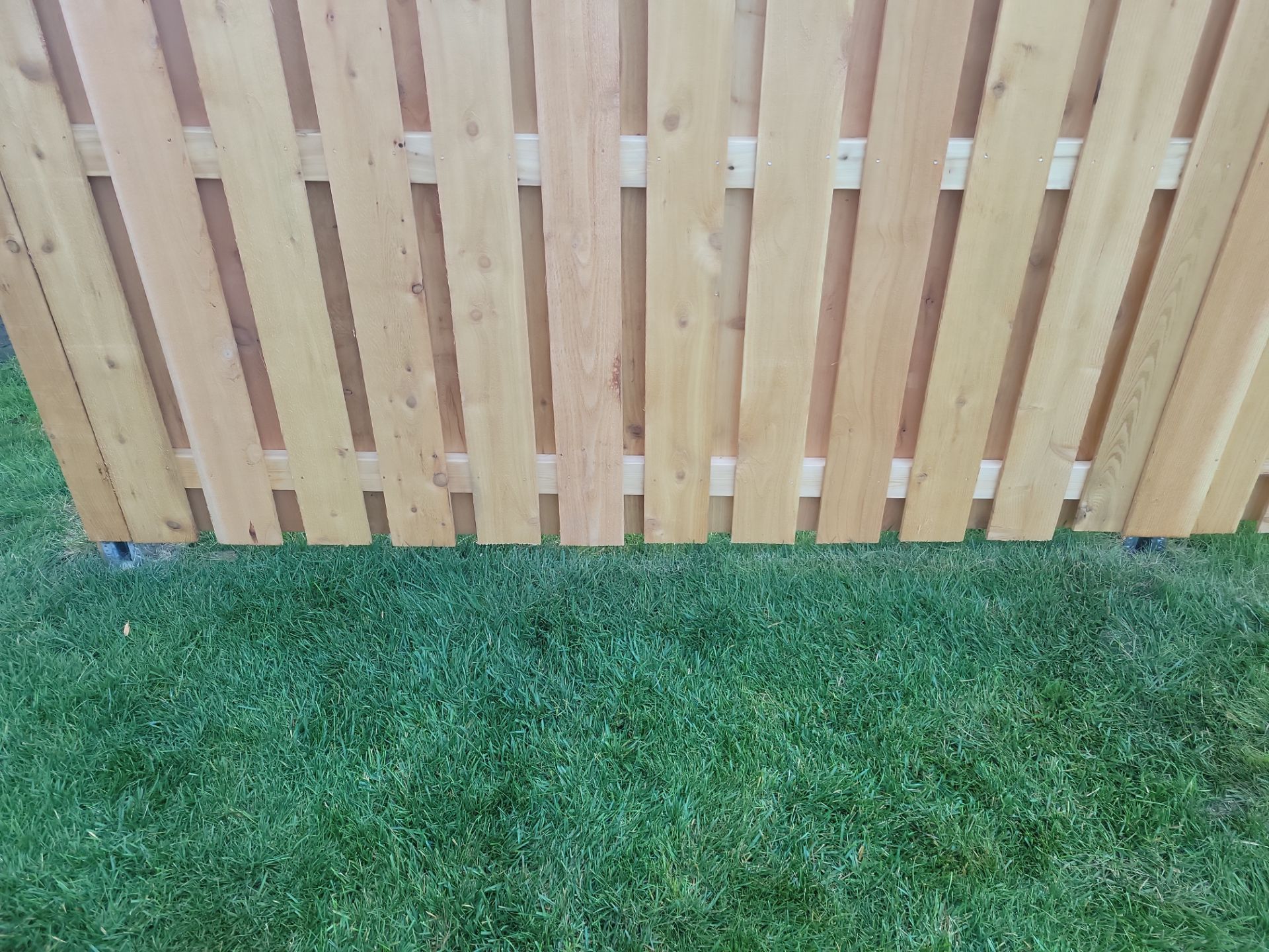 Unstained Cedar Wood Privacy Fence Installation in Cedar Falls by Perfect Picket Fence and Stain