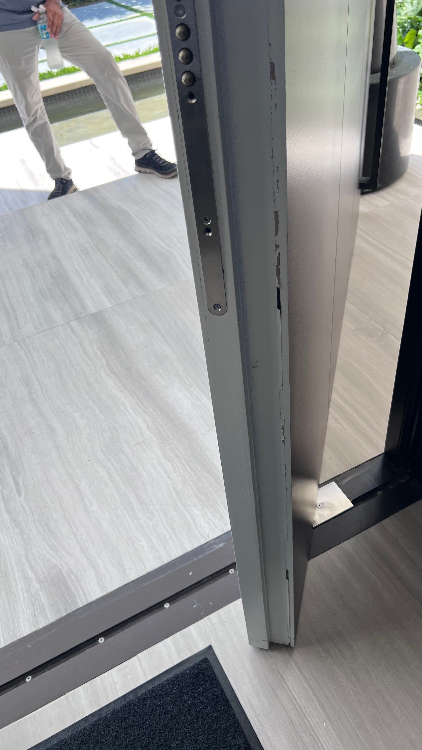 Custom Material Pivot Door installation by Impact Precious Wood Inc.