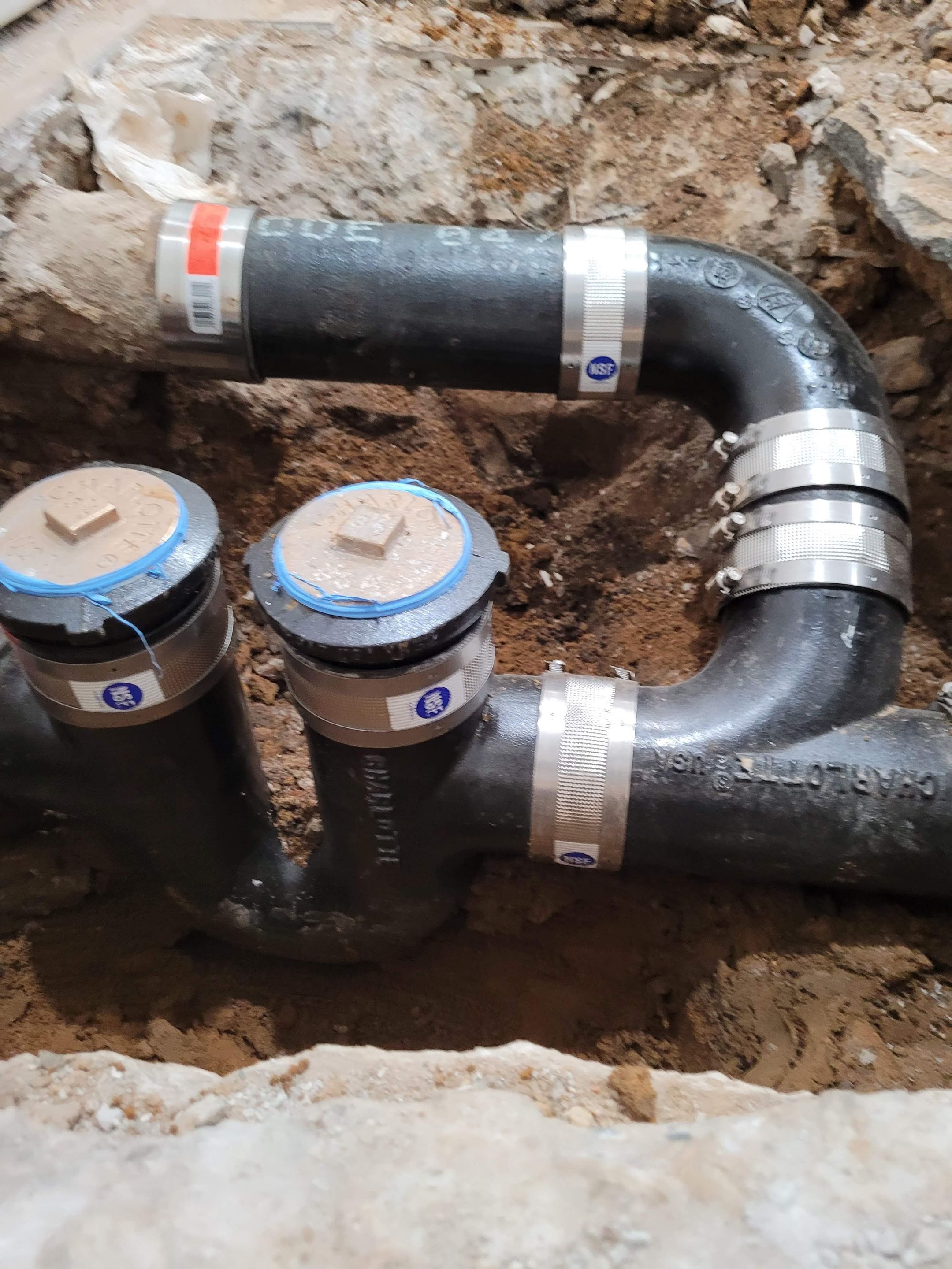 The replacement of a crumbing leaky house u-trap in basement by WG's Remodeling Inc