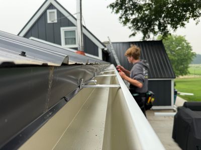 Seamless Gutter and Gutter Helmet Installation on Bellaire Metal Roof