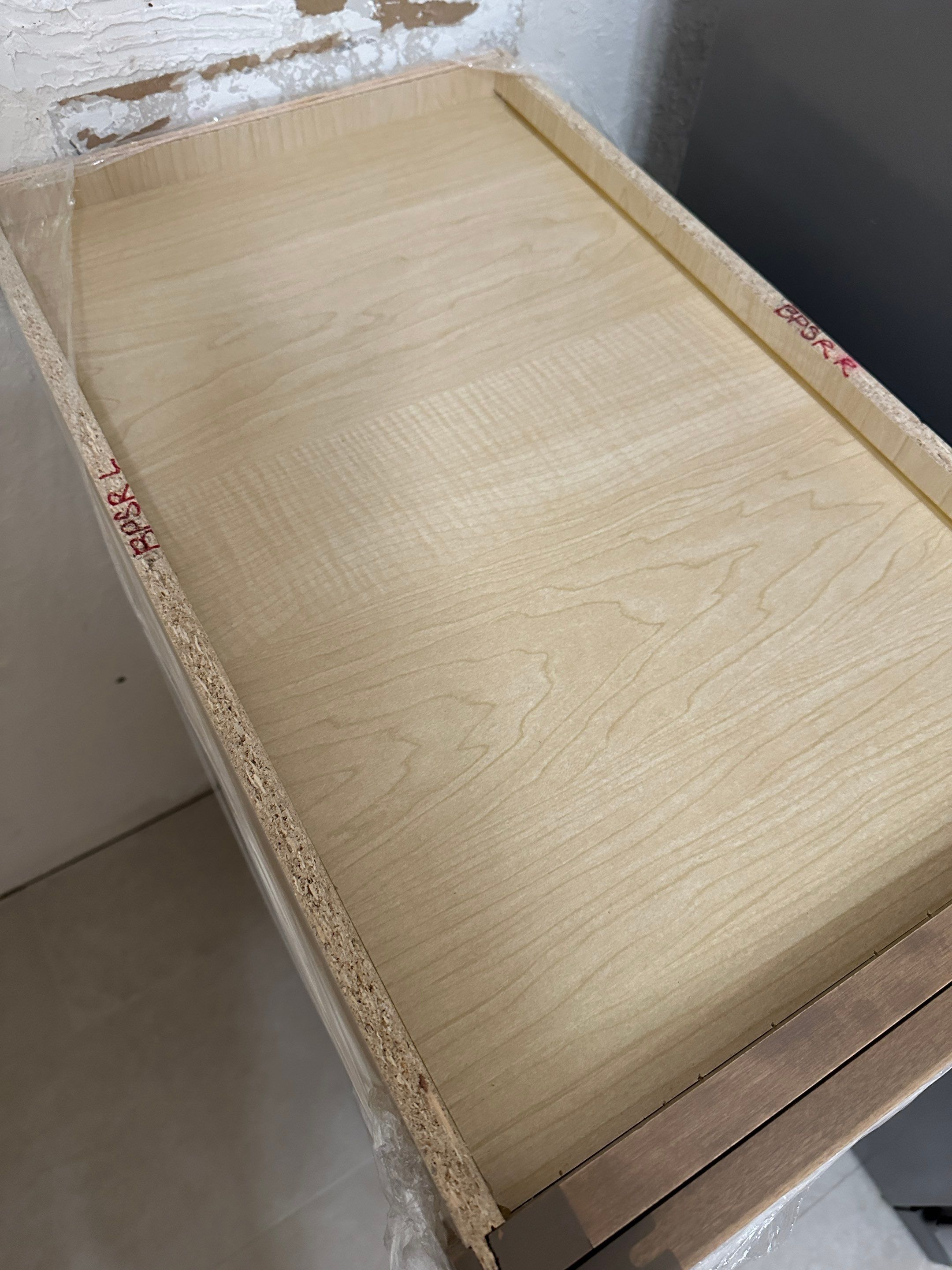 The old kitchen had a traditional builder-grade look with heavier wood cabinetry and busier finishes, while the new kitchen has a warm transitional design with cleaner lines, a brighter palette, and a more open, modern layout by Mena stone surfaces