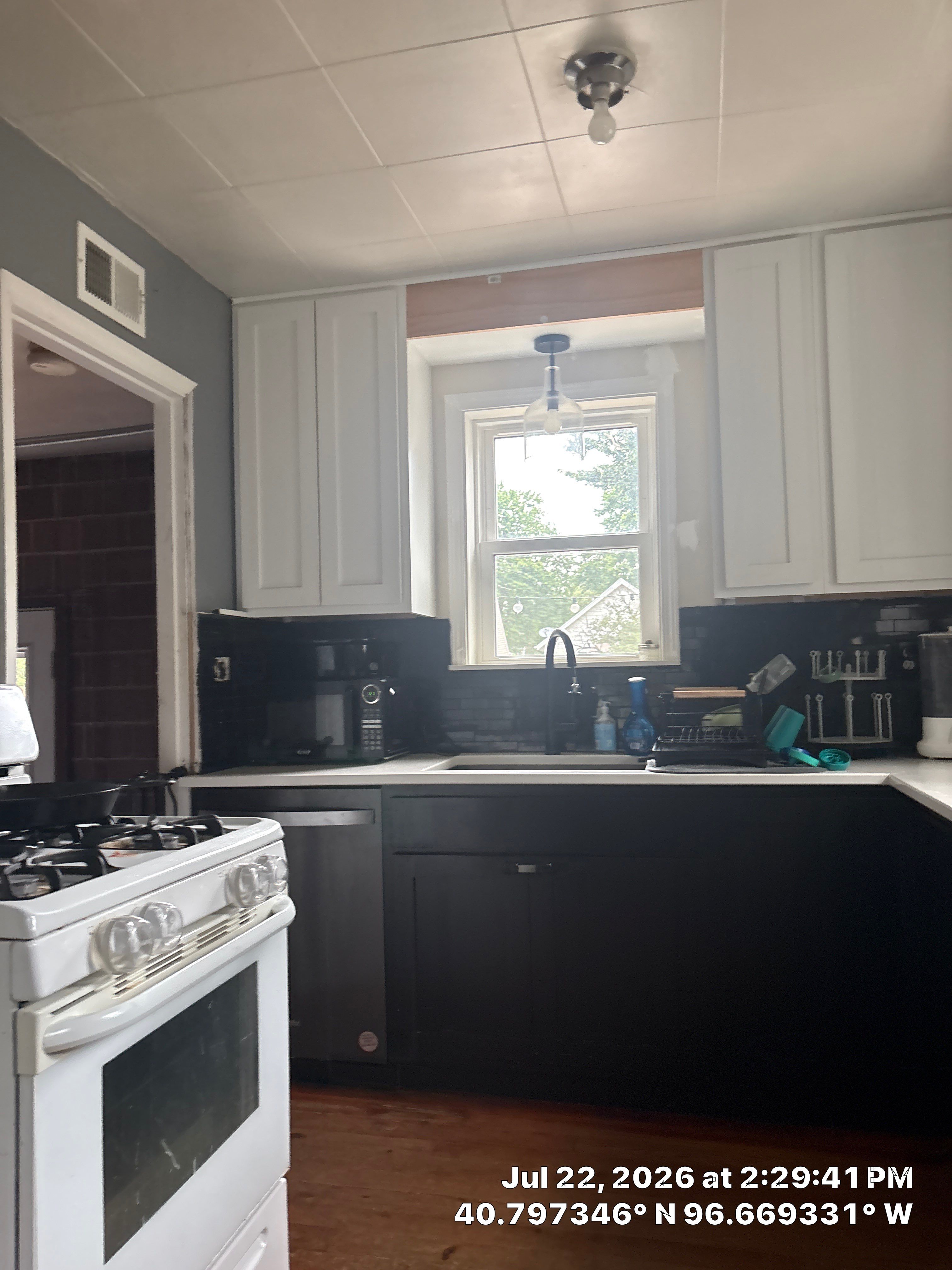 Modern Kitchen Renovation with Two-Tone Cabinetry and Quartz Countertops by CompanyCam Sales Demo