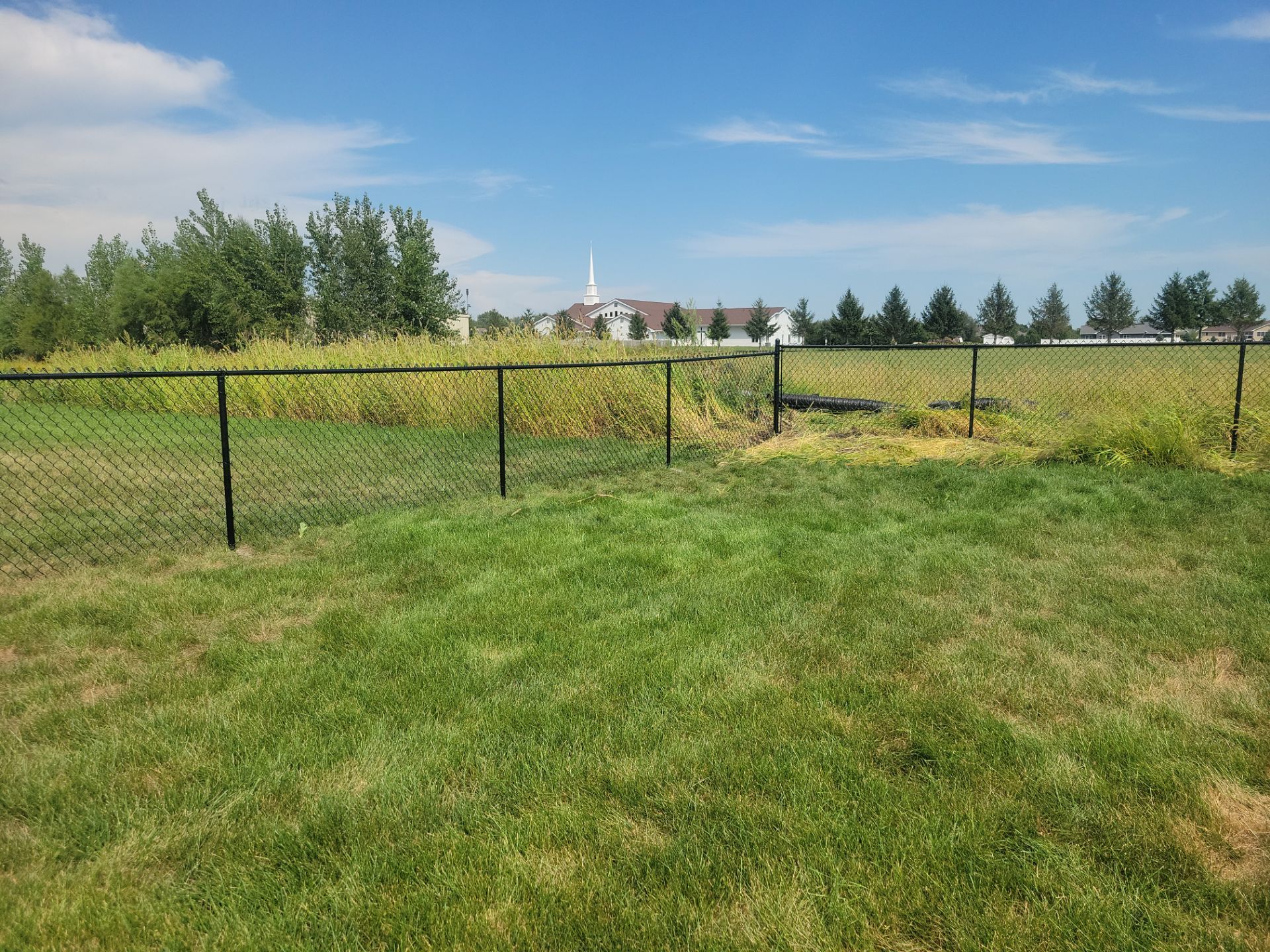 Residential Black Chain Link Fence Installation in Jesup by Perfect Picket Fence and Stain