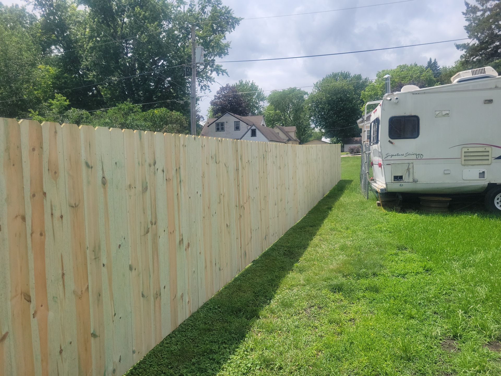 Pressure-Treated Wood Privacy Fence Installation in Charles City by Perfect Picket Fence and Stain