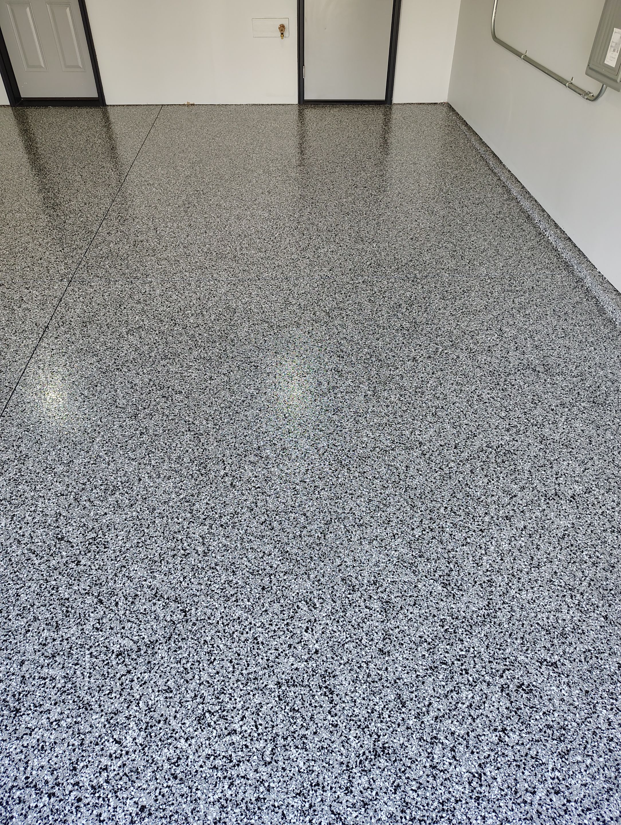 Custom Epoxy Garage Floor Coating Installation in Sioux Falls by Select Painting, Coatings & Garage Cabinets
