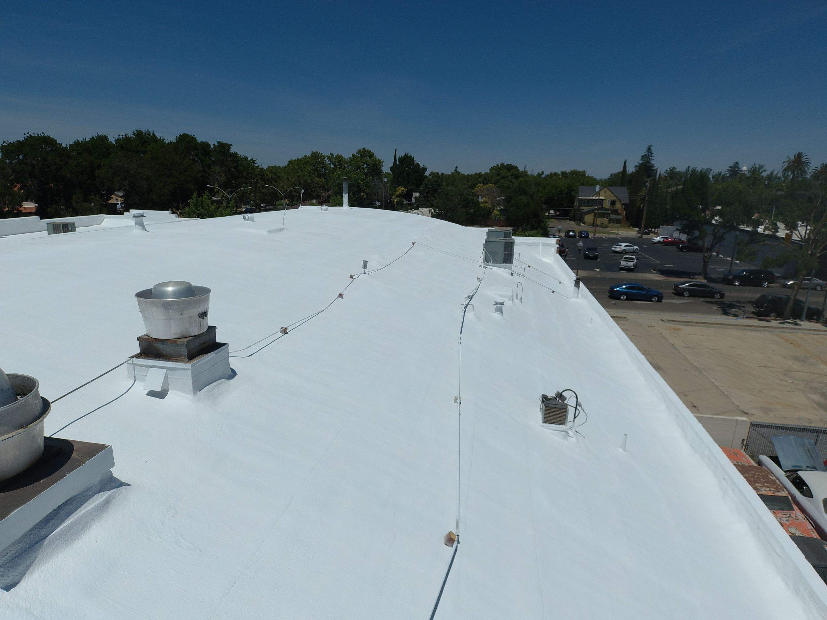 Spray foam and coatings using Conklin Benchmark/PUMA XL coatings and spray foam by Straight Edge Roofing Inc