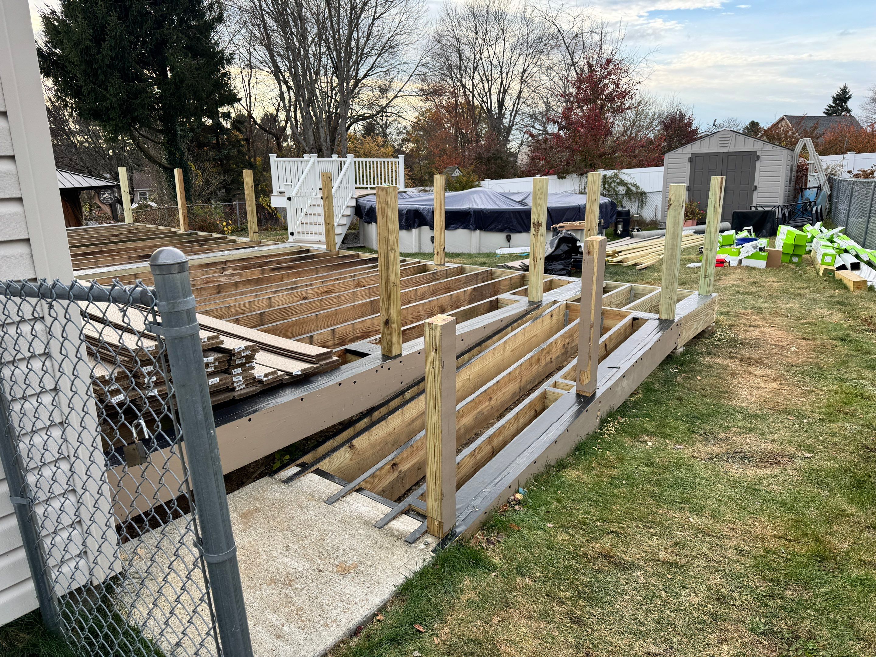 New pool deck and main deck resurface using Trex Transcend Rope Swing boards, White railing and Lattice by DiGiorgi Roofing and Siding Inc
