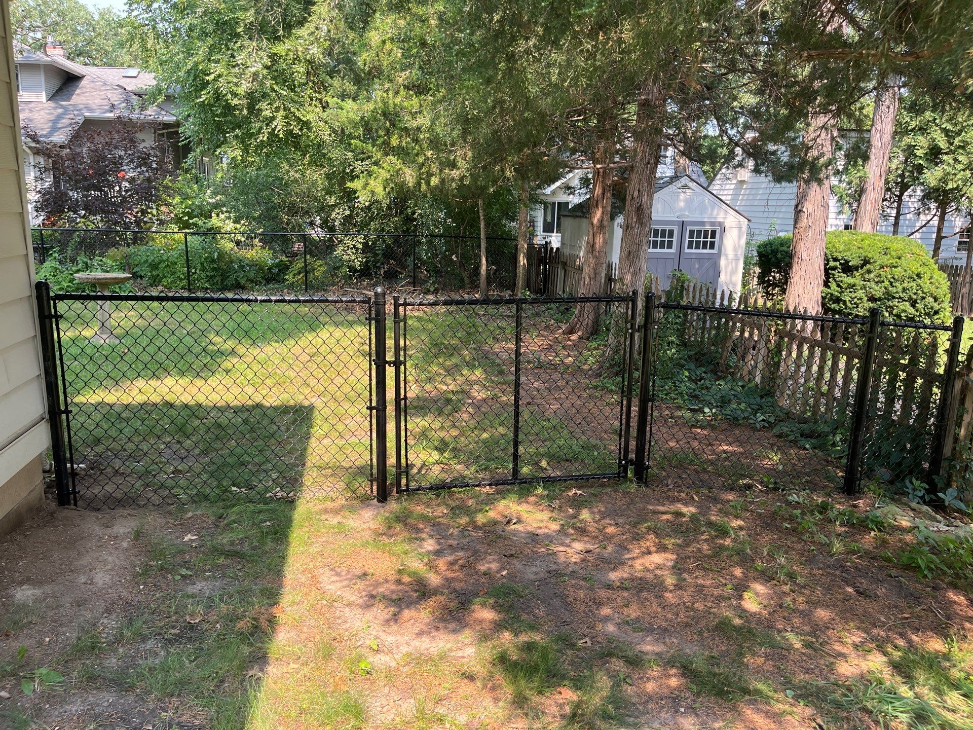 Residential Black Chain Link Fence Installation in Cedar Falls by Perfect Picket Fence and Stain