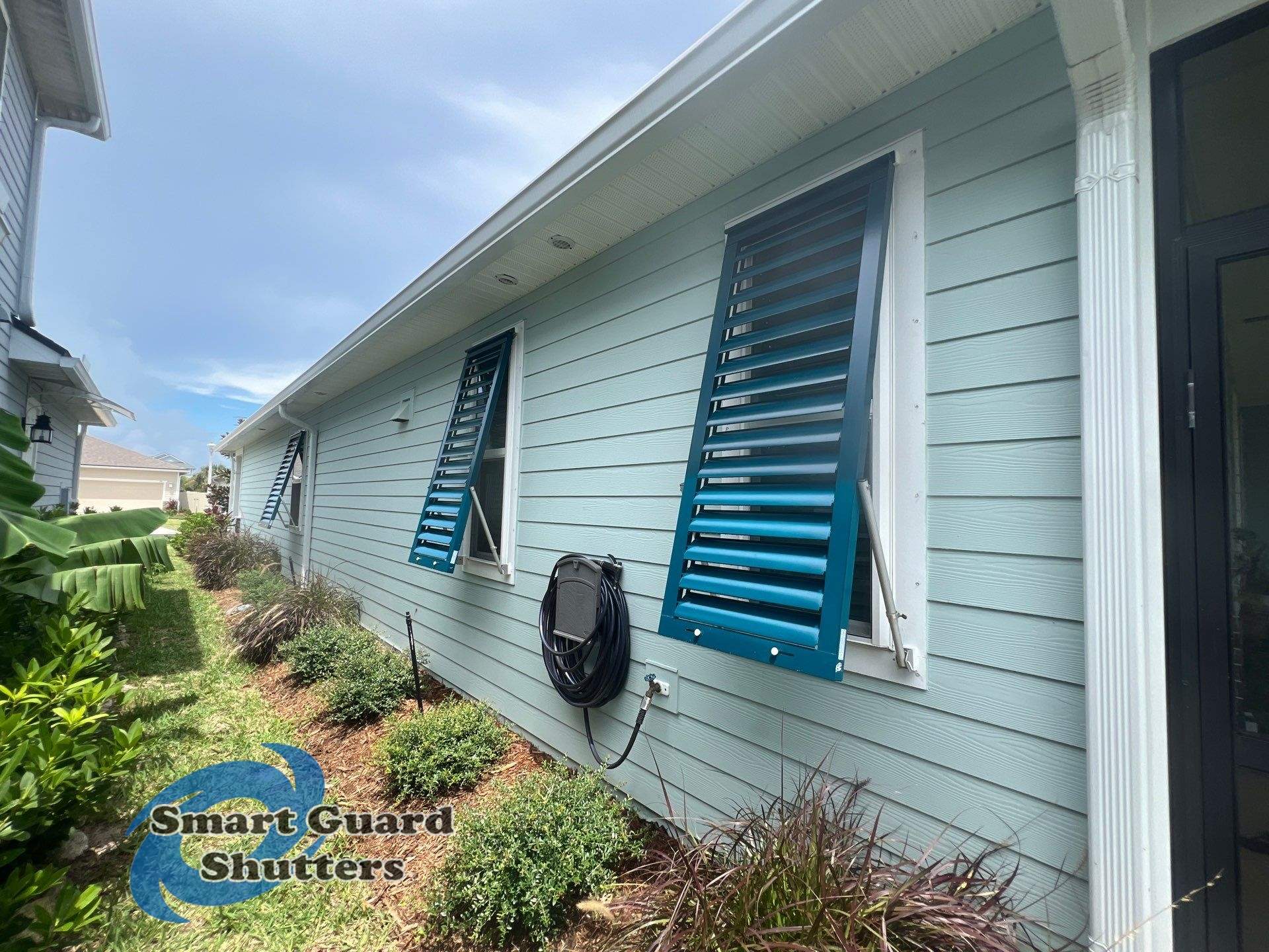 Impact Bahama Shutters in Ocean Blue by Smart Guard Shutters
