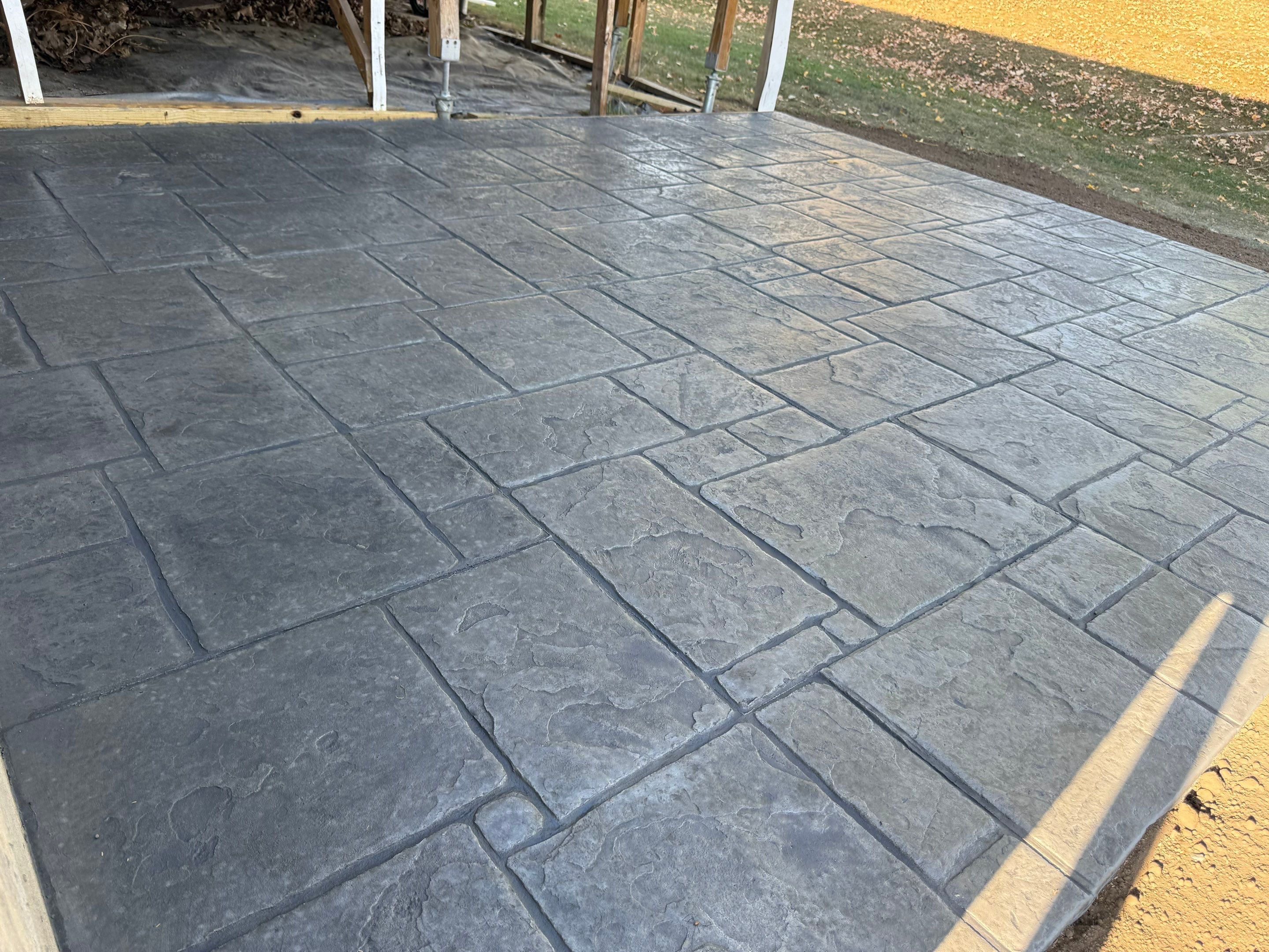 Stamped English Rivenstone concrete patio and sidewalks  by NG Masonry & Construction LLC