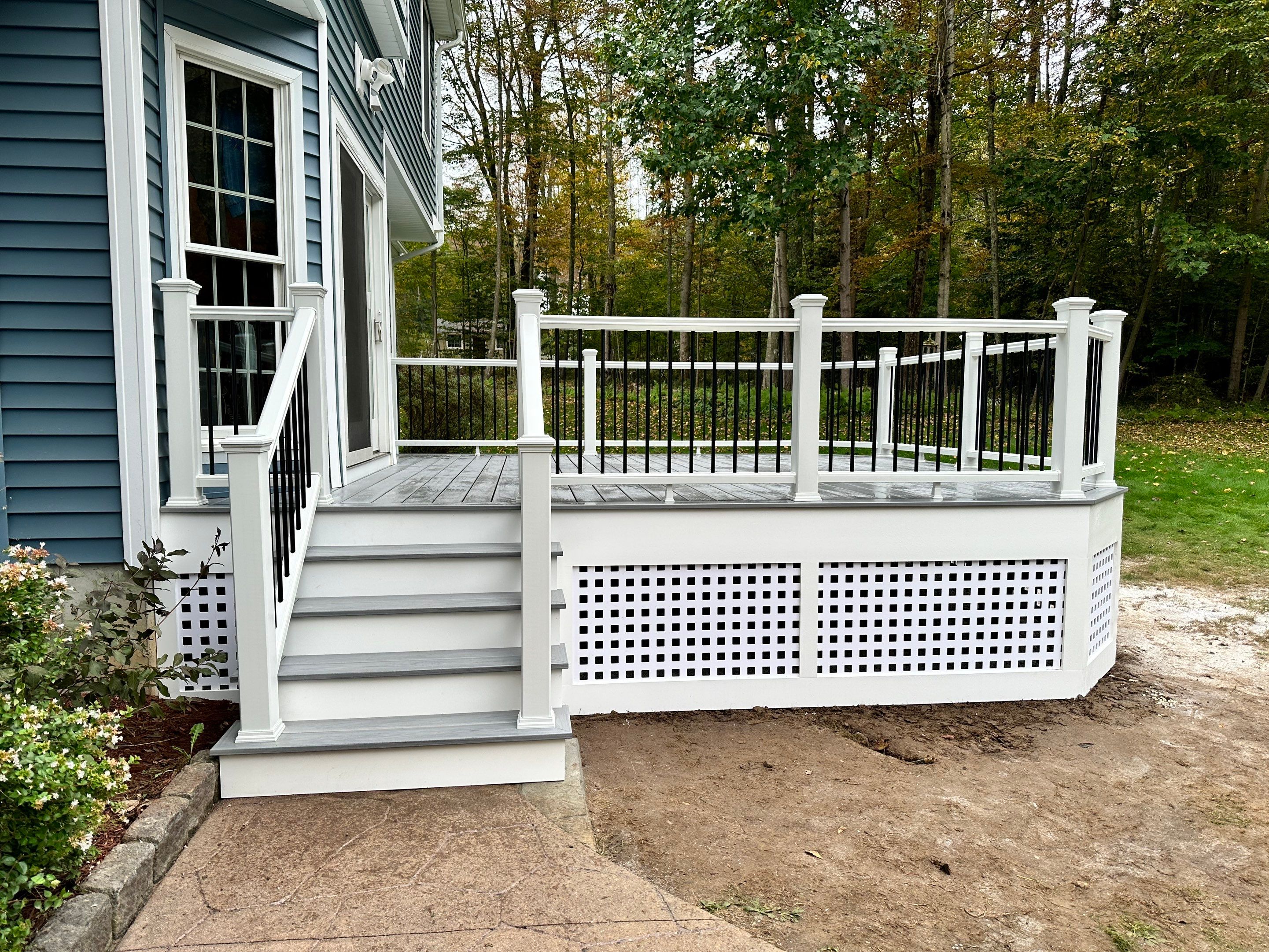Deck replacement using Trex lineage Rainier with angled edges, Transcend cocktail rail and lattice. by DiGiorgi Roofing and Siding Inc