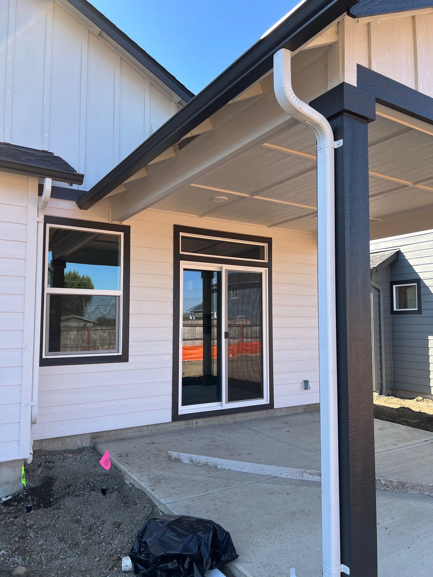 Continuous White Gutter and Downspout Installation for New Eugene Home by BEST Roofing & Waterproofing