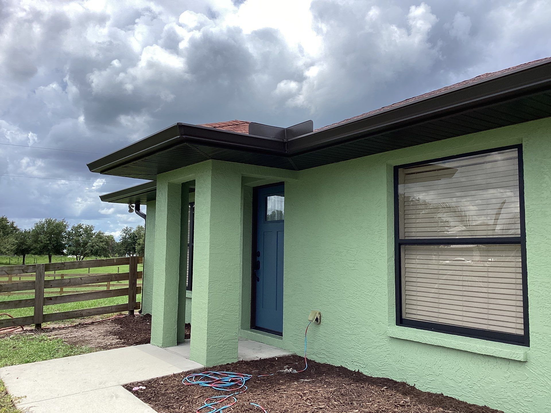 Musket brown downspouts with 6-inch K-Style gutter installation in Myakka City, FL by Gutter Professors