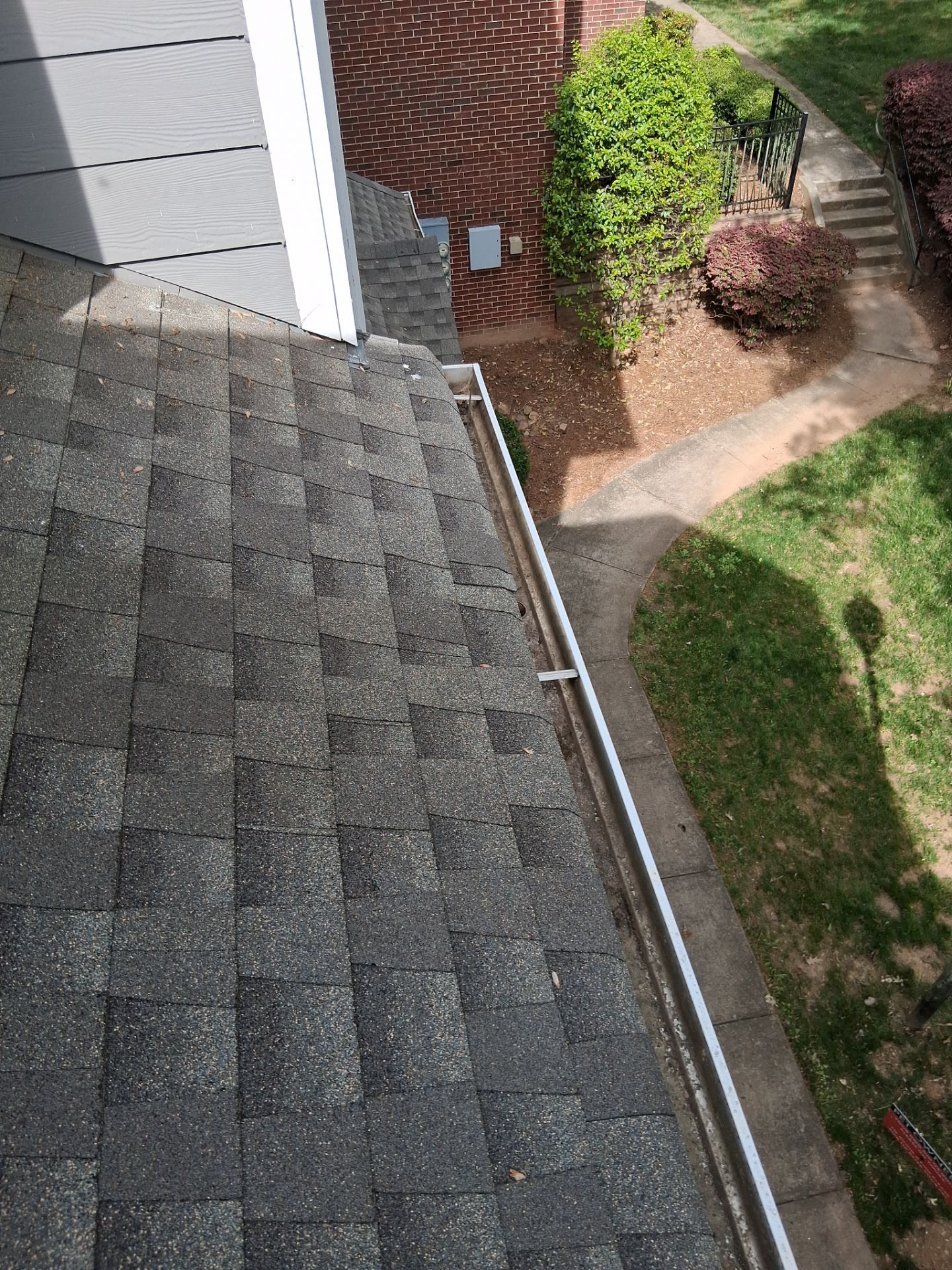HOA gutter cleaning in Huntersville, NC, after  photo showing full gutters.