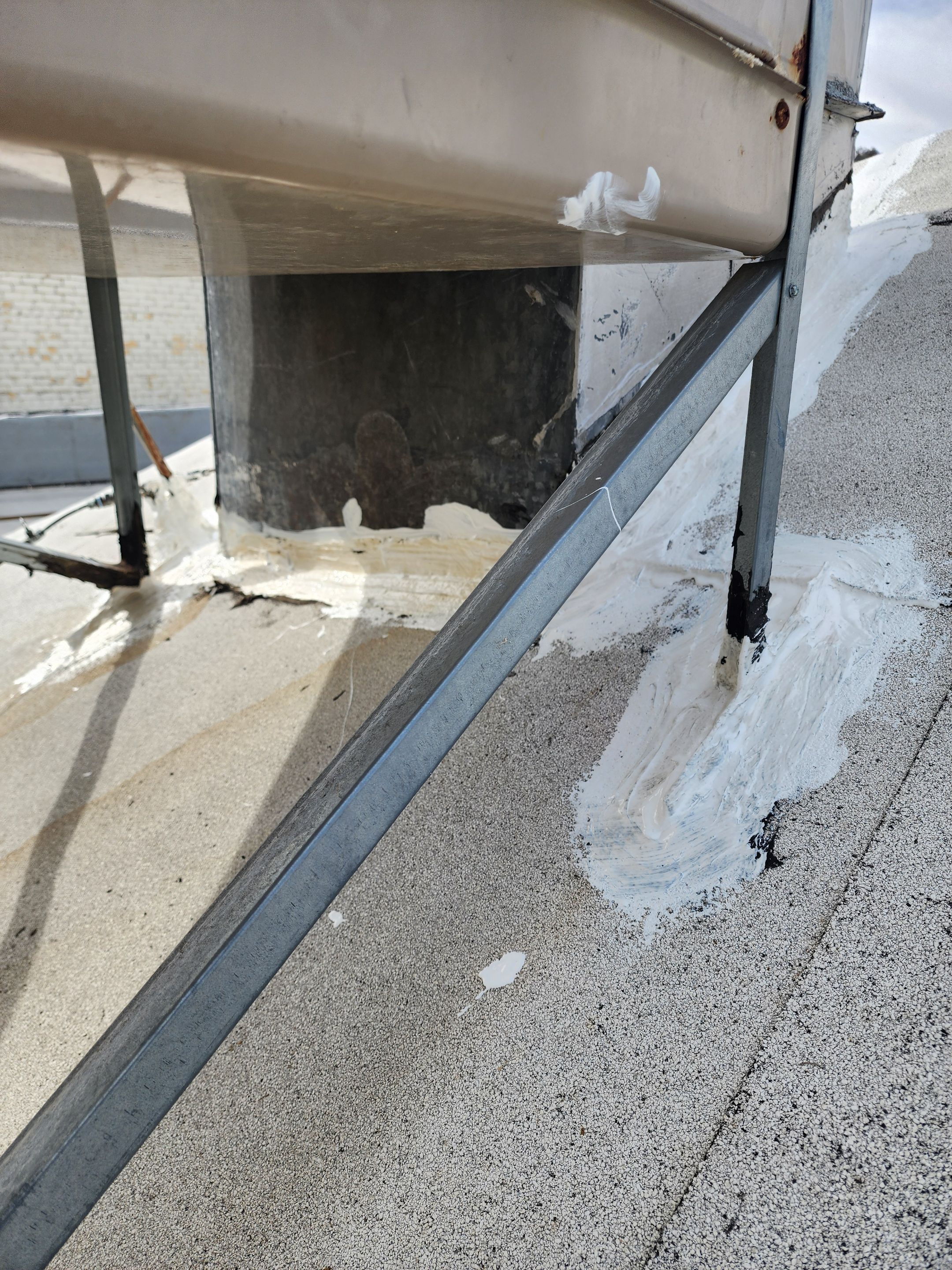 Foam and coatings on commercial roof by Straight Edge Roofing Inc