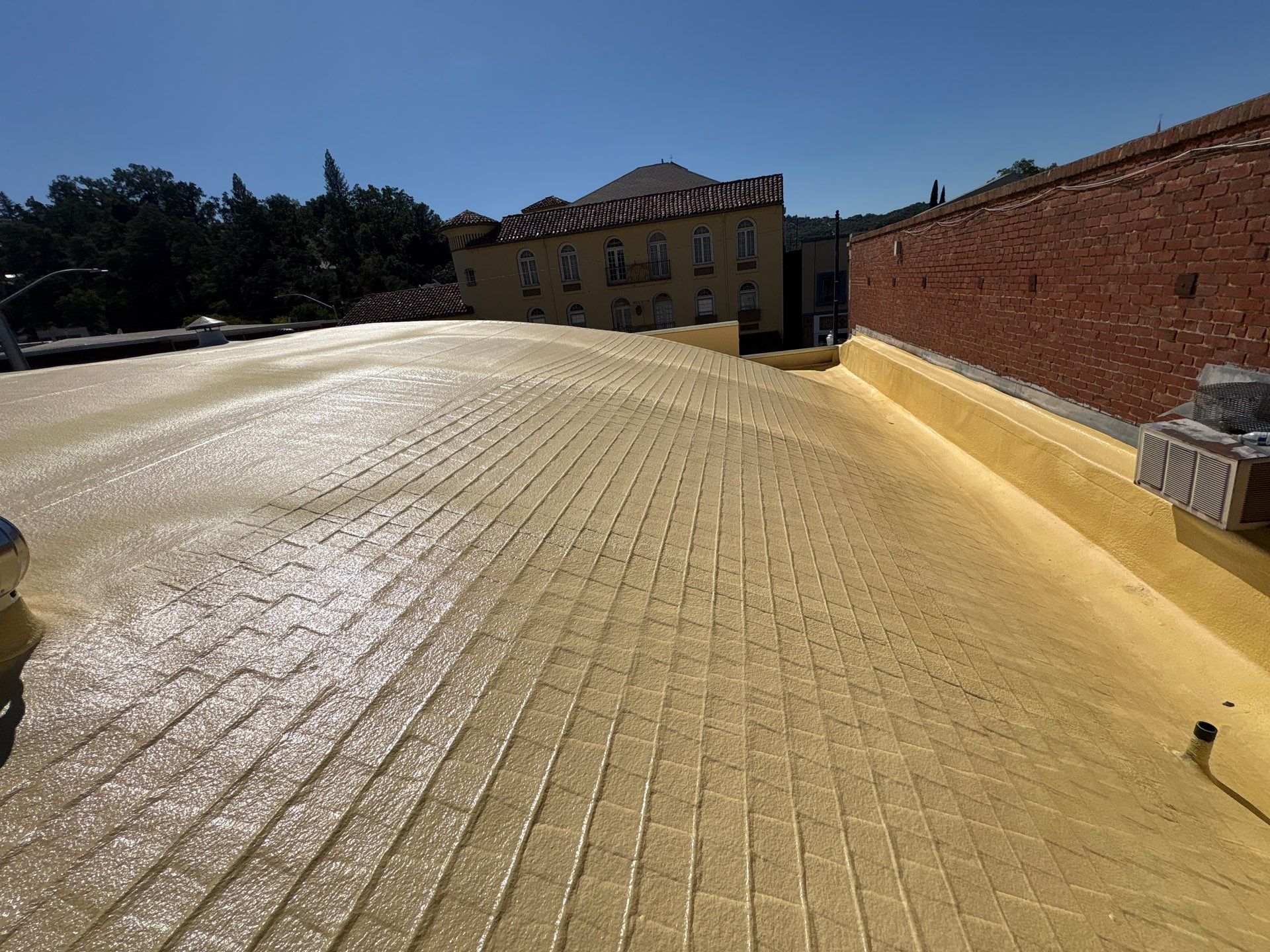 Foam and coatings on commercial roof by Straight Edge Roofing Inc