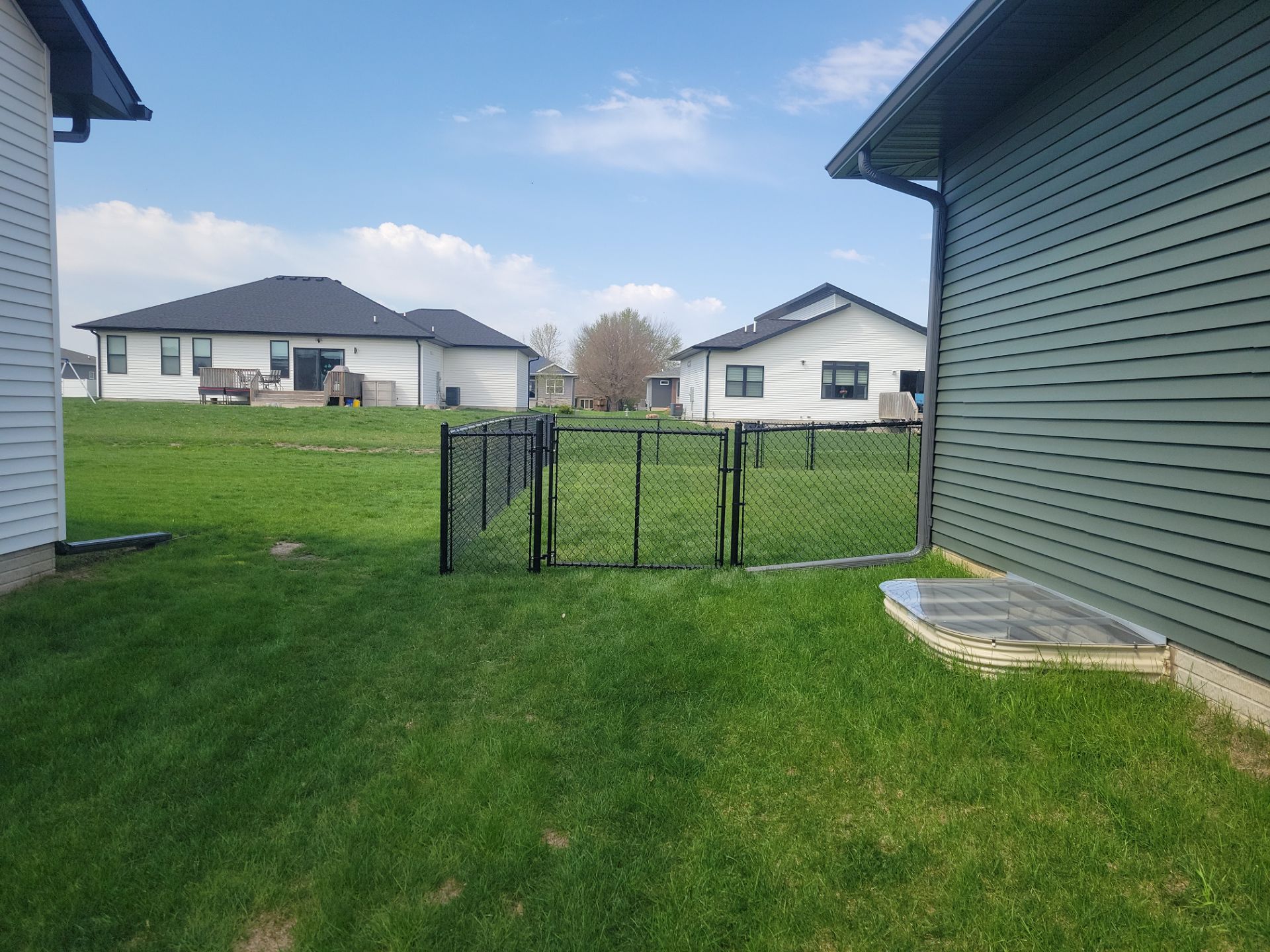 Black Chain Link Fence and Gate Installation in Cedar Falls by Perfect Picket Fence and Stain