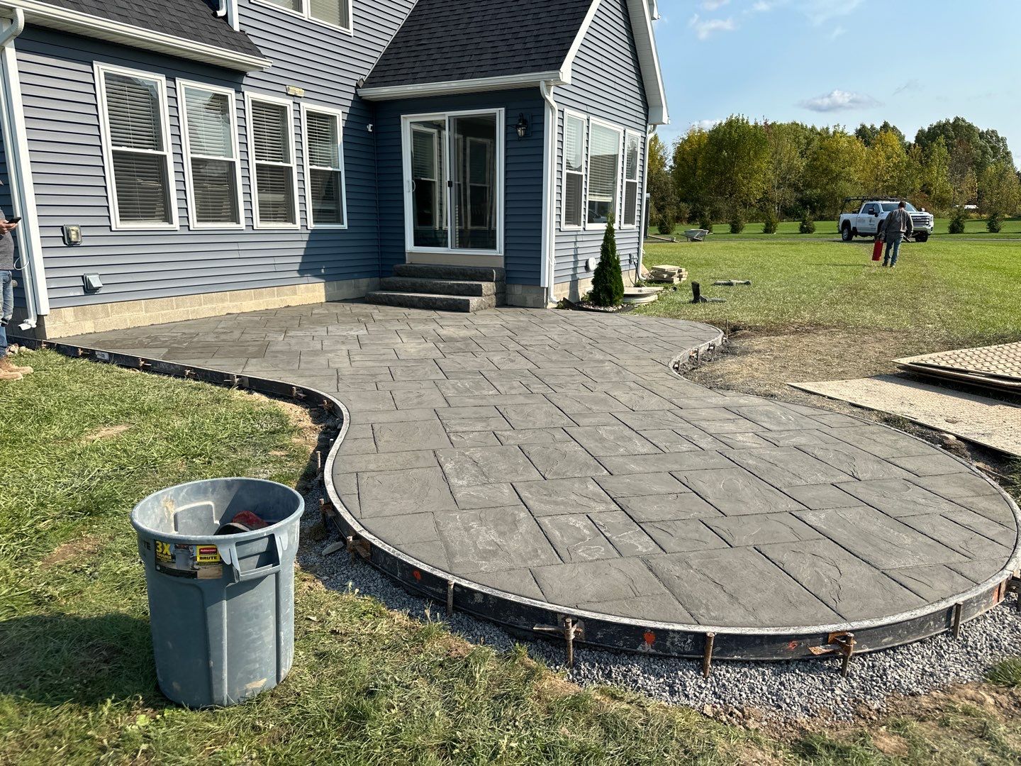 Majestic Ashlar stamped concrete patio with rock face steps  by NG Masonry & Construction LLC