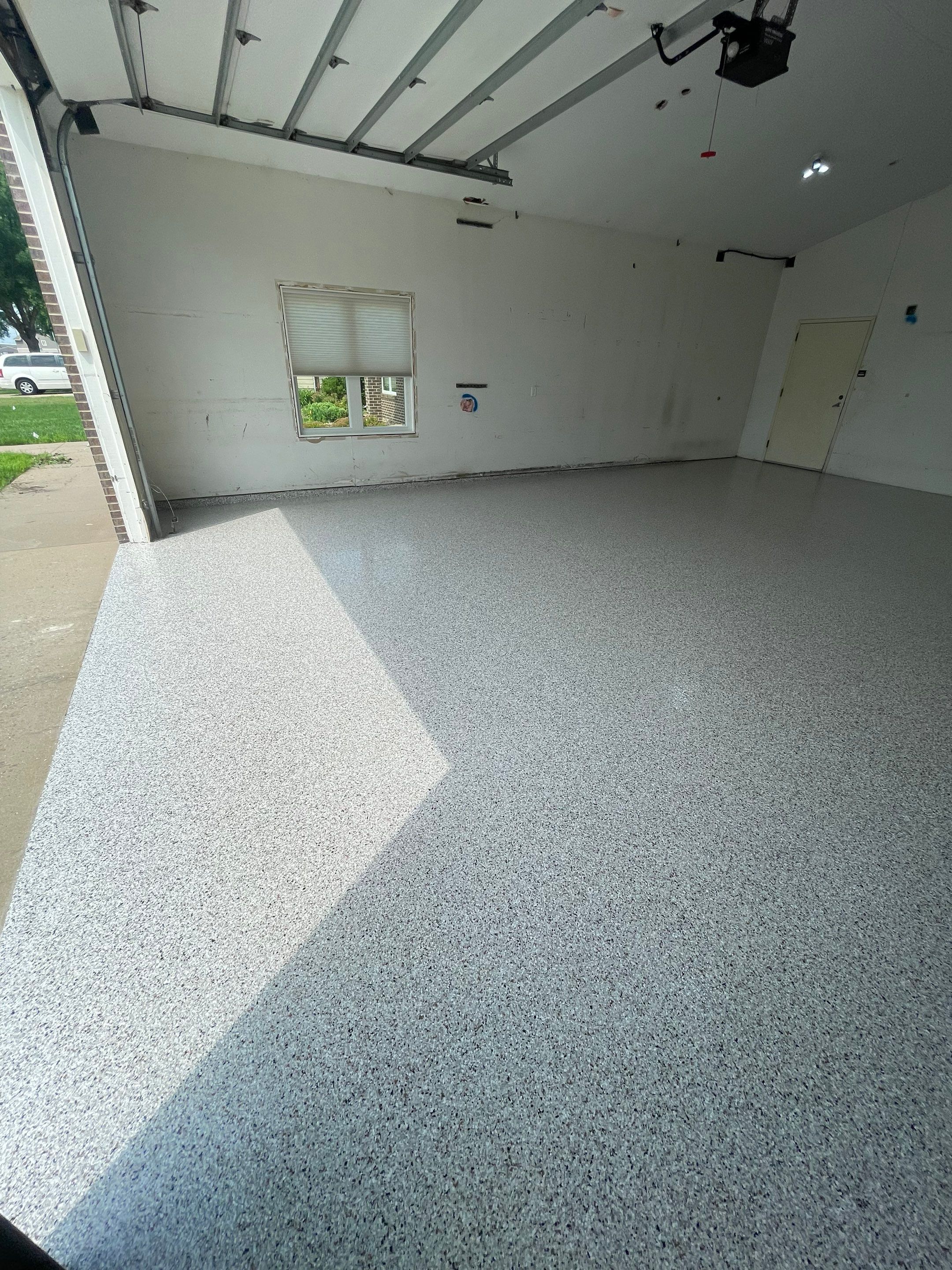 Coyote Flake Concrete Coating for Sioux Falls Garage by Select Painting, Coatings & Garage Cabinets