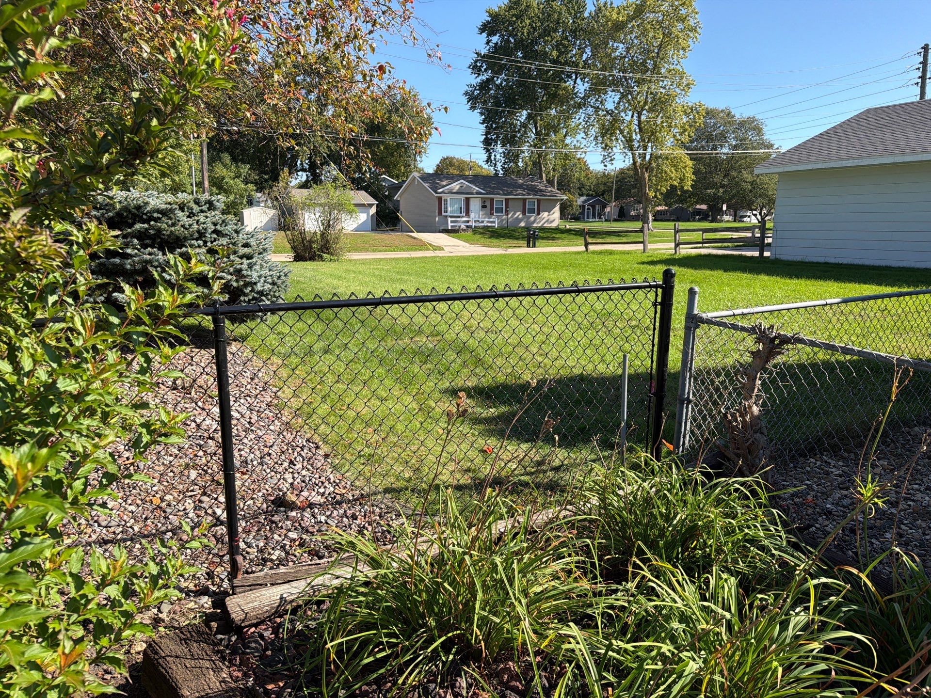 Custom Vinyl Privacy and Black Chain Link Fence Installation in Cedar Falls by Perfect Picket Fence and Stain