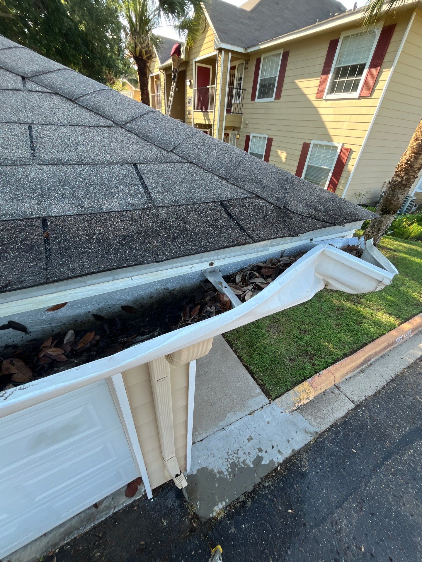 Commercial gutter cleaning McAllen & Edinburg before photo with filled gutters