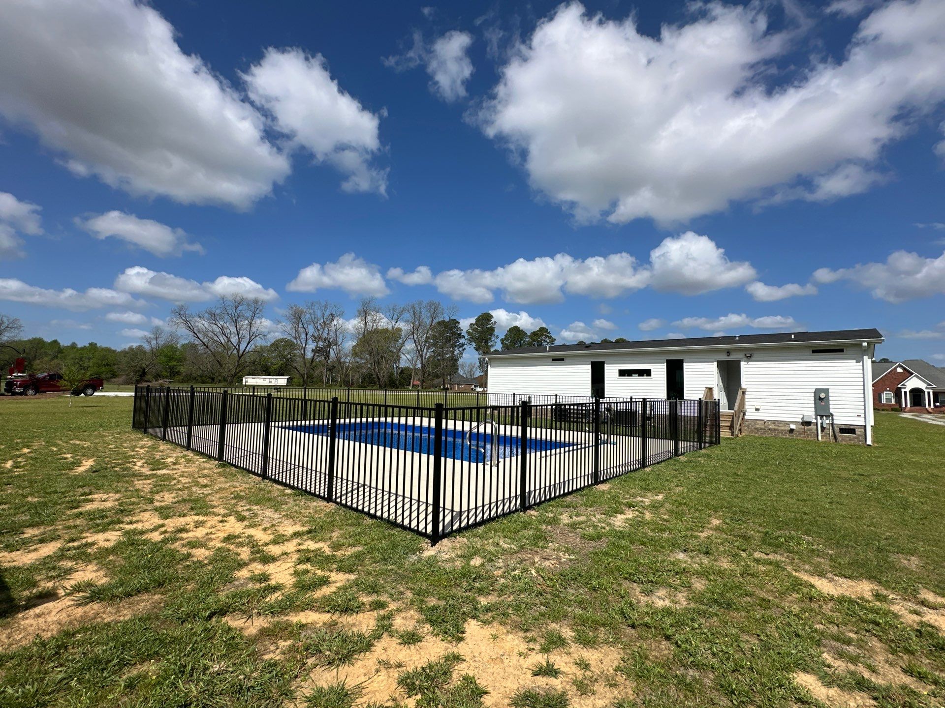 Black Aluminum Pool Fence Installation in Whiteville, NC by Superior Fence and Rail