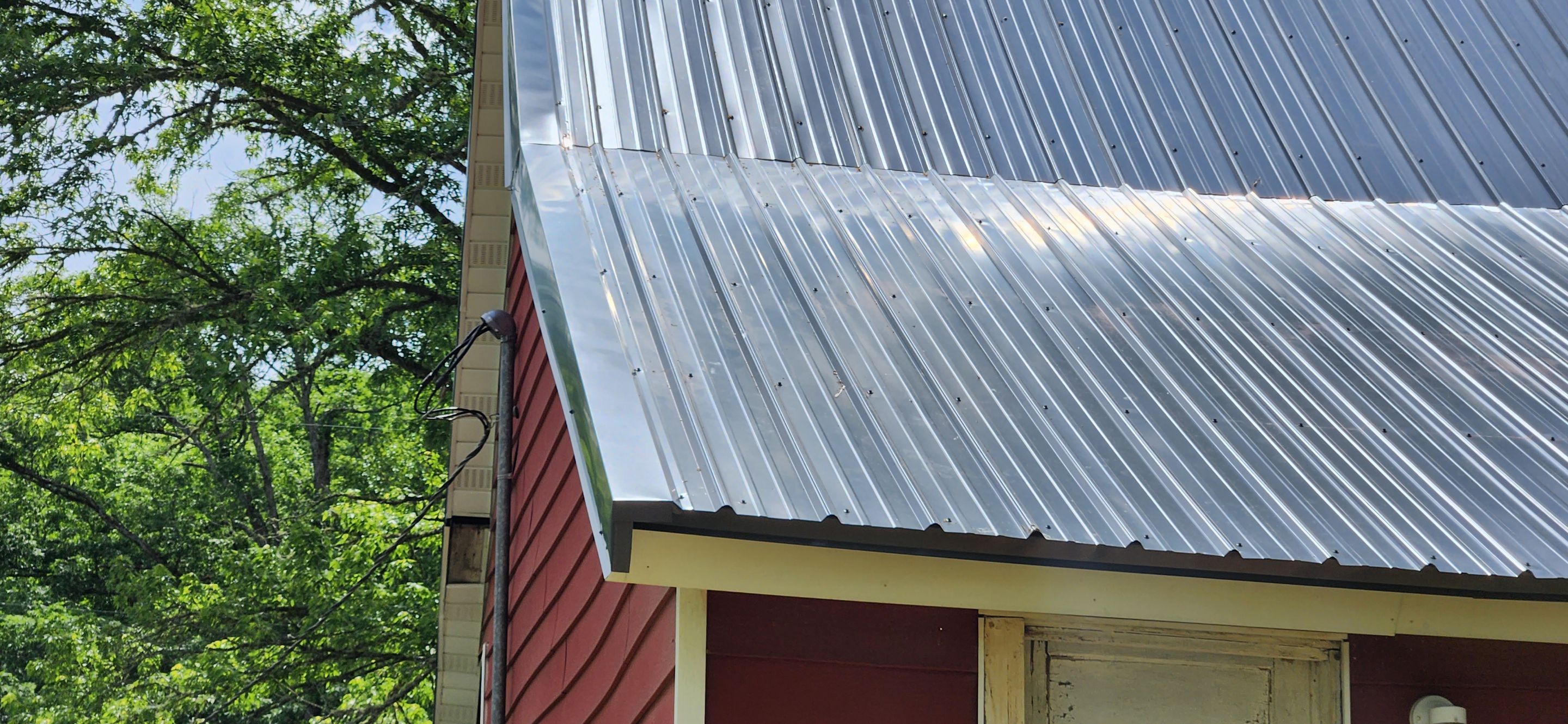 Residential Roofing Installation using 26 Gauge Colored Panels by Hostetler Roofing